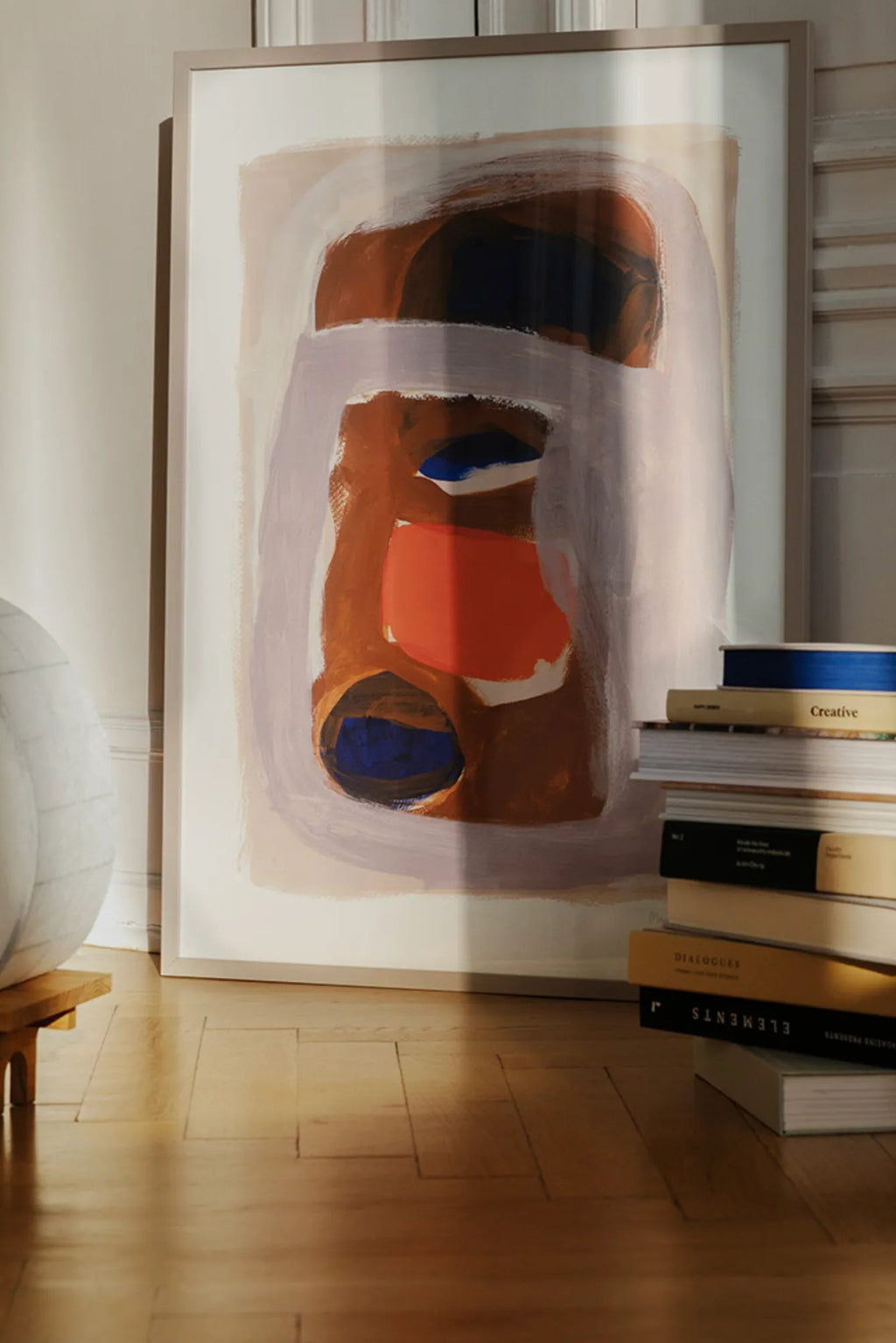 The Poster Club Outline, a contemporary abstract art print featuring organic painterly brushstrokes in warm brown, deep blue, coral, and soft lavender tones on a creamy white background, presented in a sleek light beige frame. This expressive abstract poster is ideal for adding modern style and a pop of color to gallery walls, living rooms, or bedrooms in contemporary and organic modern interiors.