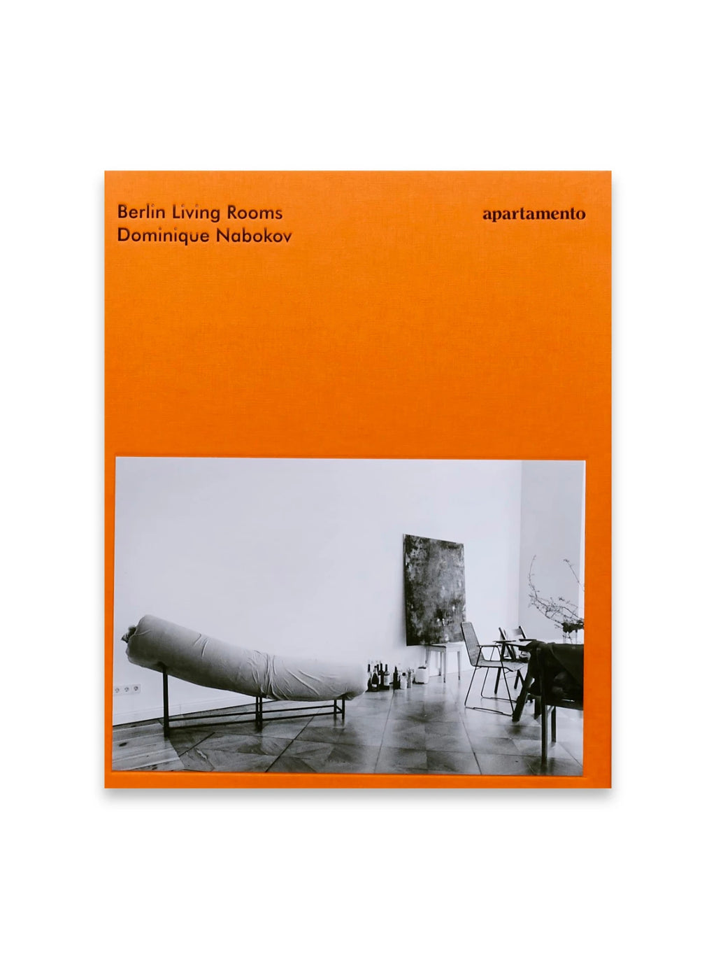 Book Berlin Living Rooms, a vibrant orange book cover with a textured finish, featuring a black and white interior photograph of a minimalist Berlin living room with a chaise lounge and modern art. This captivating book is perfect for design enthusiasts, architecture students, and anyone interested in contemporary interior design.