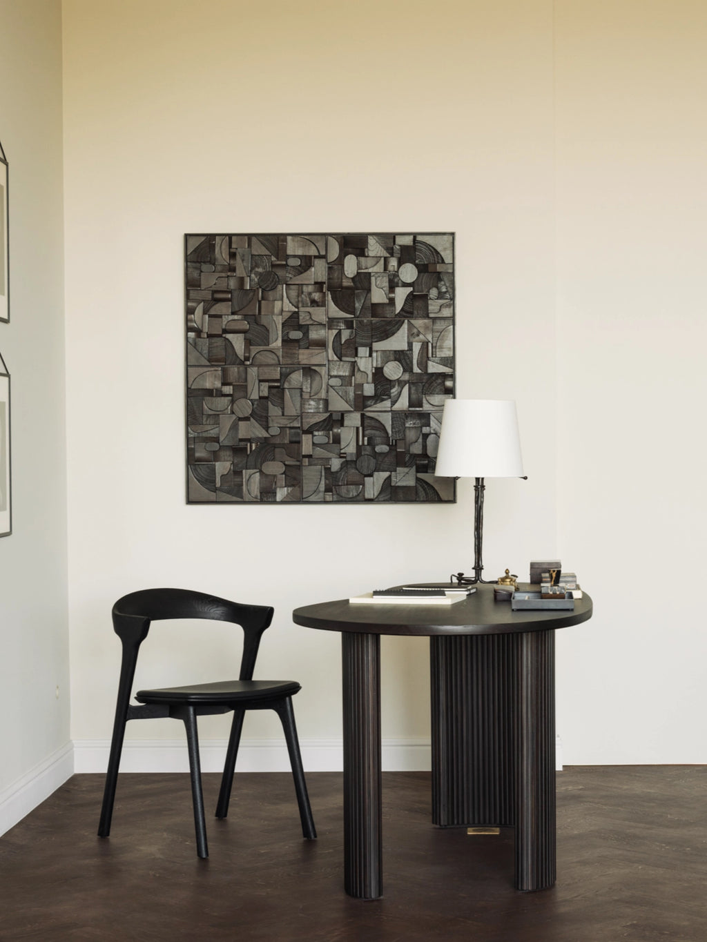 Ethnicraft Bricks Wall Art, a striking square abstract wall panel crafted from dark reclaimed wood featuring a complex geometric design of carved, varying-depth blocks, circles, and arcs in charcoal and deep grey.