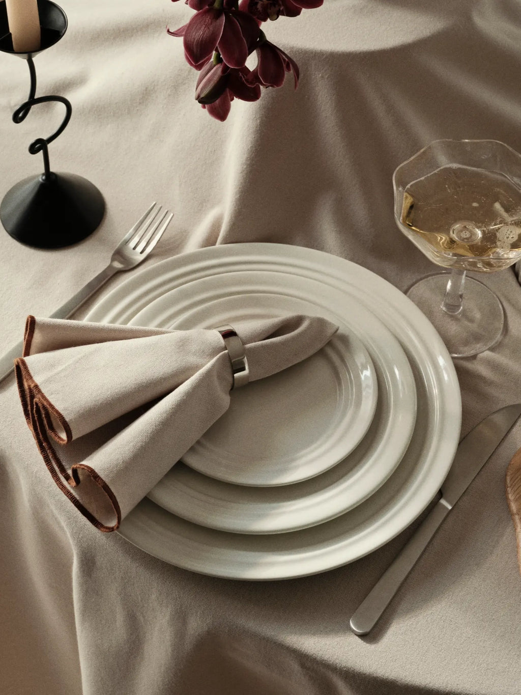 Broste Copenhagen Stevns Dinner Set for 4, a minimalist stoneware dinnerware set featuring a sophisticated light grey matte finish with subtle ridged detailing on the dinner plates. This organic modern ceramic dinner set offers a rustic yet refined aesthetic, perfect for everyday use or special occasions. Ideal for styling contemporary Scandinavian dining rooms or modern kitchen tablescapes with a natural, understated elegance.