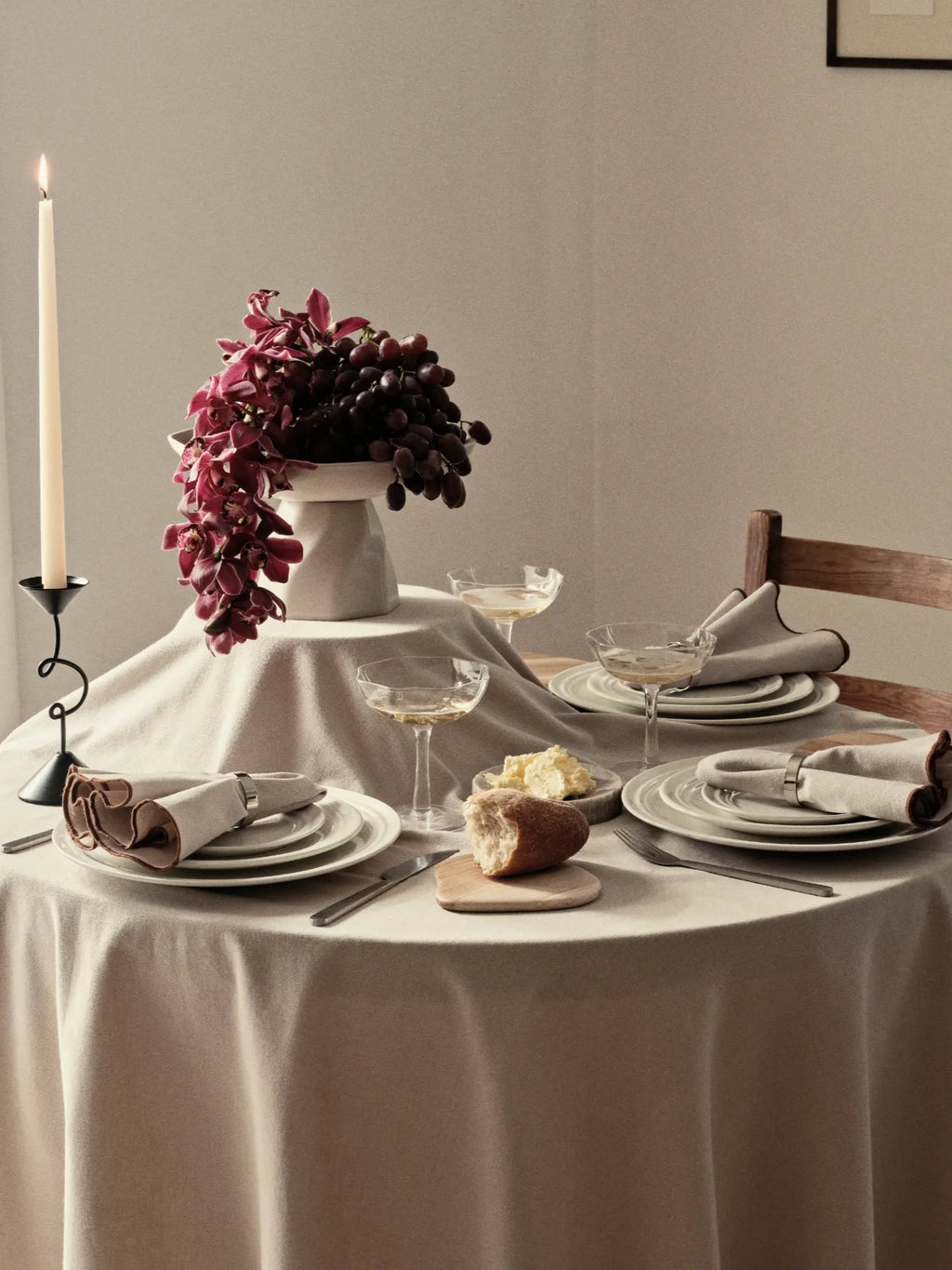 Broste Copenhagen Stevns Dinner Set for 4, a minimalist handcrafted stoneware dinnerware set in a neutral grey-white tone with a matte finish and organic, slightly textured edges. This contemporary Scandinavian dining set includes plates and bowls for four, perfect for everyday meals or elegant table settings in modern rustic or organic modern dining rooms.