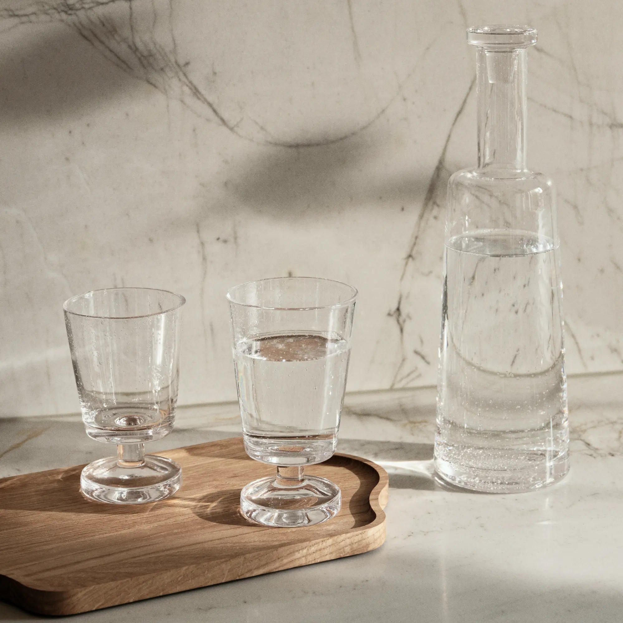 Elegant Bubble Carafe with Lid, a durable glass pitcher with a secure lid and comfortable handle, ideal for serving drinks at parties or gatherings