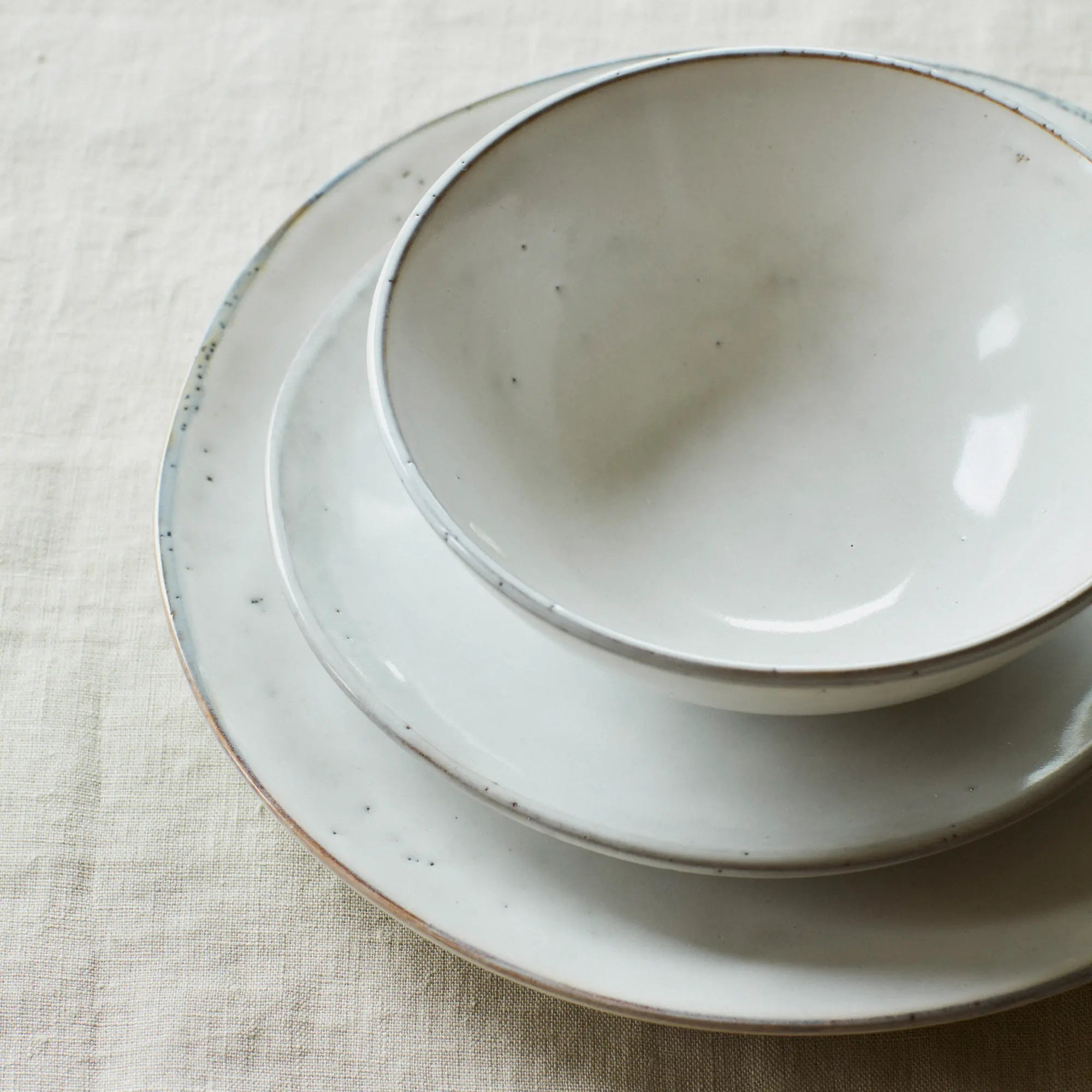  Side view of the Nordic Sand salad plate, highlighting its organic shape and smooth finish