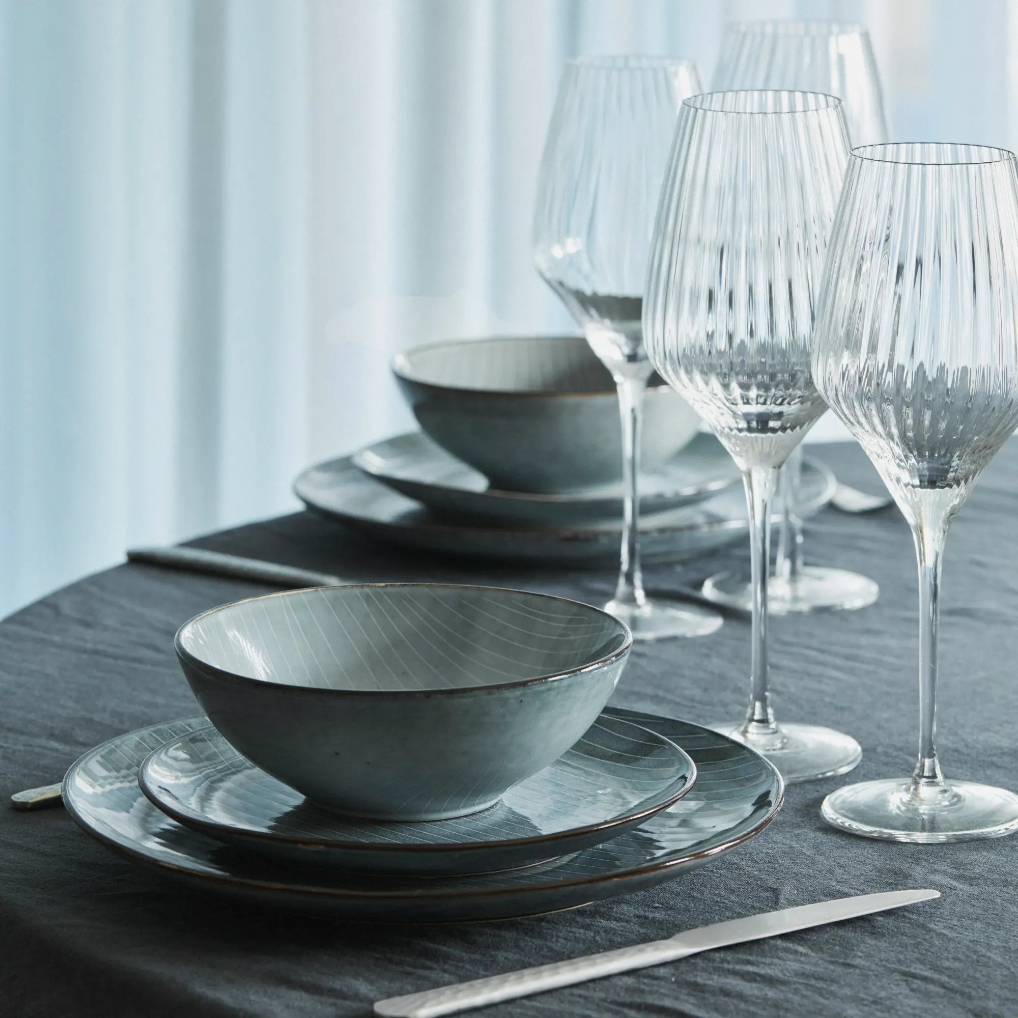 Complete dinnerware set including plates, bowls, and mugs in a serene sea-inspired design