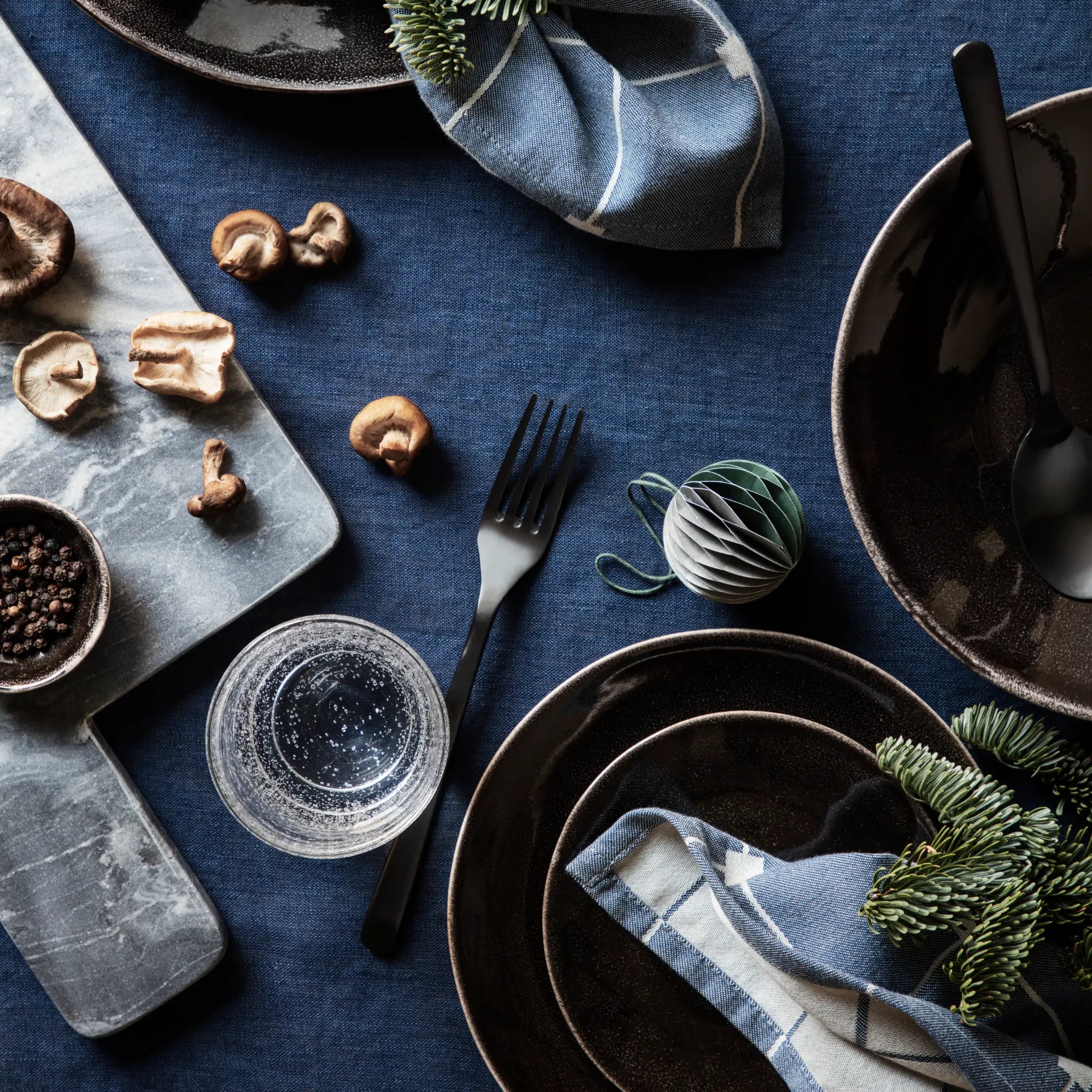 Stacked Nordic Coal Dinner Set for 4 with matching mugs, bowls, and side plates