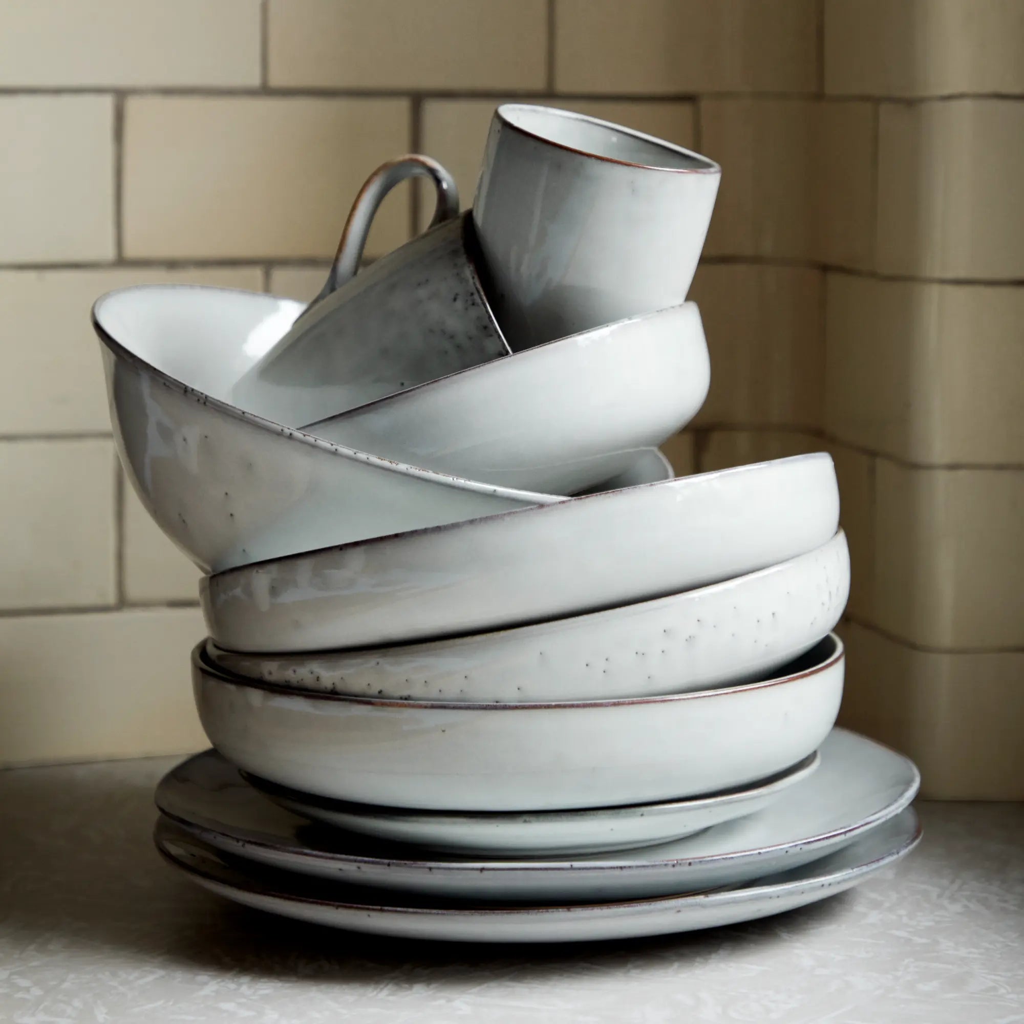  A close-up of the Nordic Sand dinnerware, revealing its artisanal craftsmanship and timeless aesthetic