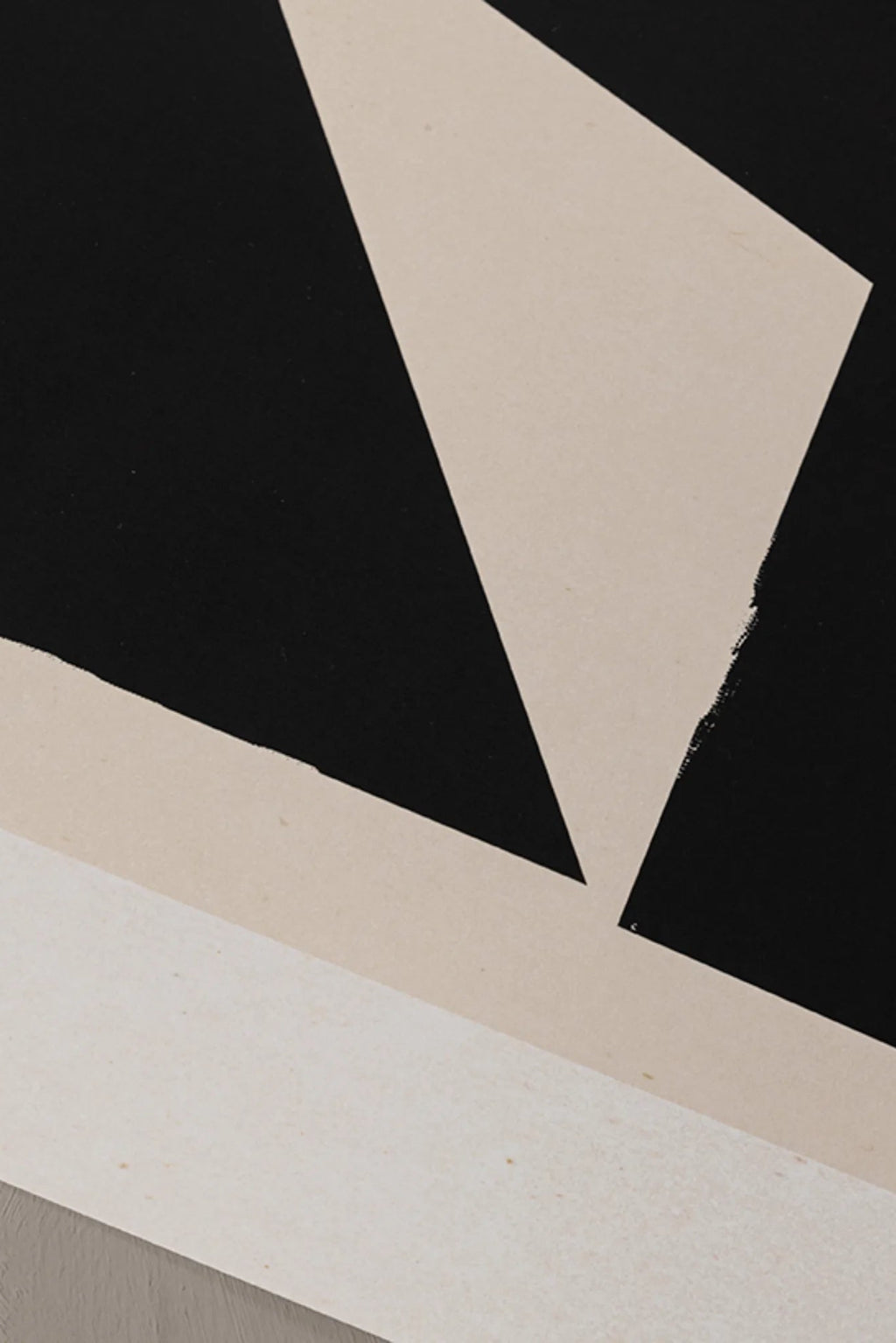 The Poster Club Facesing, a minimalist abstract art print showcasing bold black geometric shapes against a warm beige background, forming a dynamic composition with clean lines and subtle textural edges.