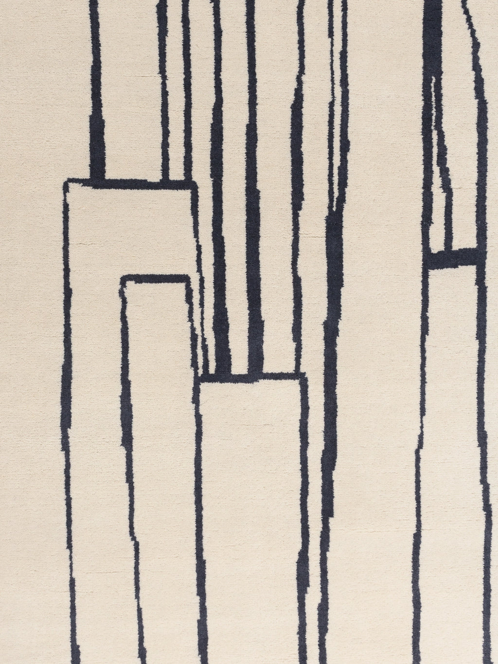 Haus Üger Contour Rug, a modern abstract area rug featuring a plush cream-colored tufted pile with bold, hand-drawn dark navy vertical lines and geometric shapes. This minimalist wool rug creates an organic modern aesthetic, perfect for contemporary living rooms, bedrooms, or design-forward home offices.