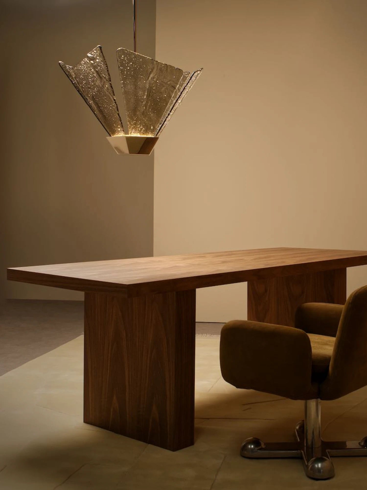 CTO Lighting Shard Pendant Light, a luxury contemporary ceiling light featuring multiple textured amber glass panels arranged in an organic, fan-like shard design, radiating from a faceted brushed brass base. This artisanal hand-blown glass pendant creates a warm, inviting glow, perfect as a statement fixture for modern dining rooms or elegant living spaces.