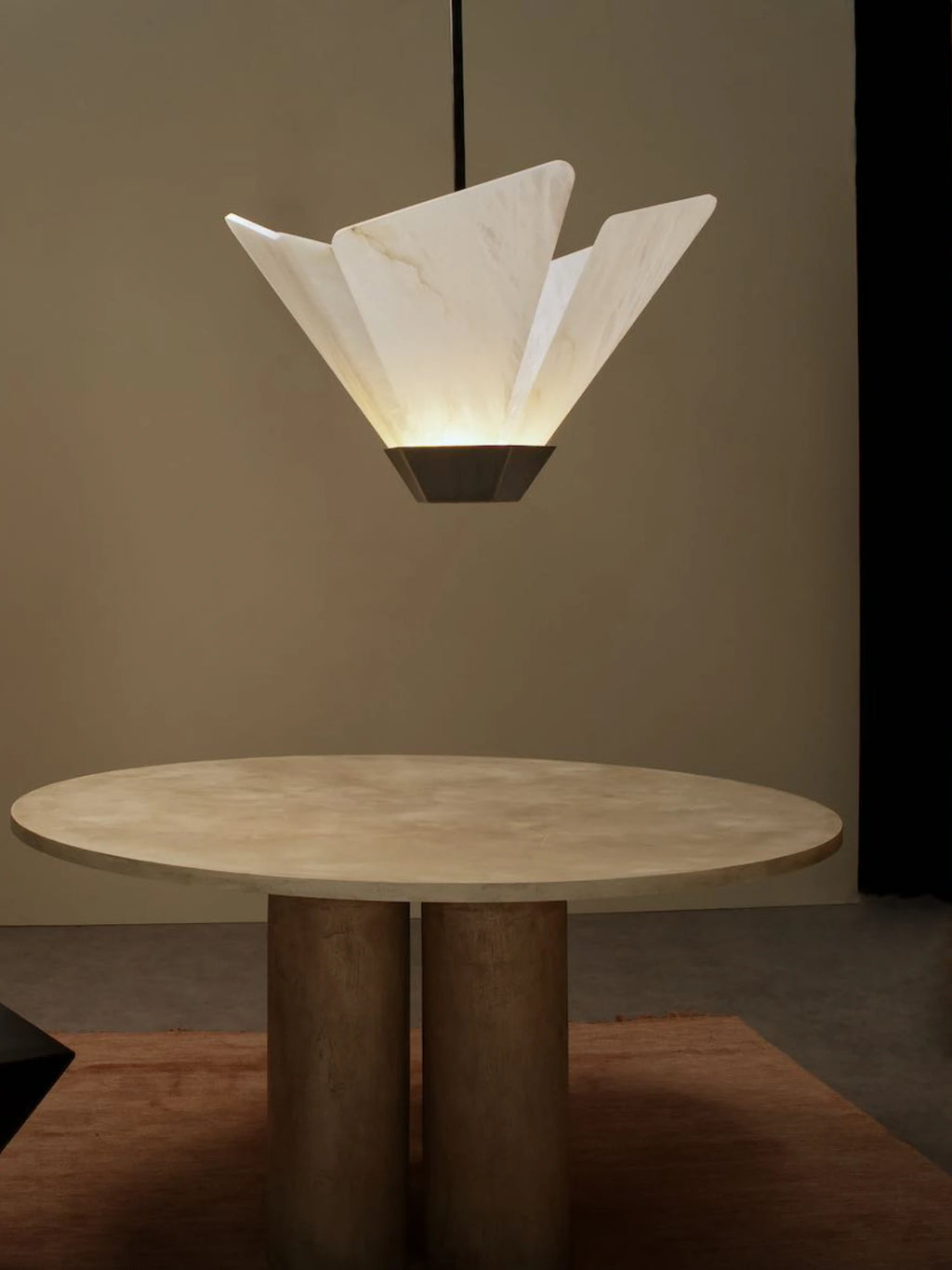 CTO Lighting Shard Pendant Light, a luxury contemporary ceiling light featuring multiple translucent alabaster panels arranged in a striking geometric, sculptural form, casting a warm glow. It is suspended from a dark bronze metal fixture.