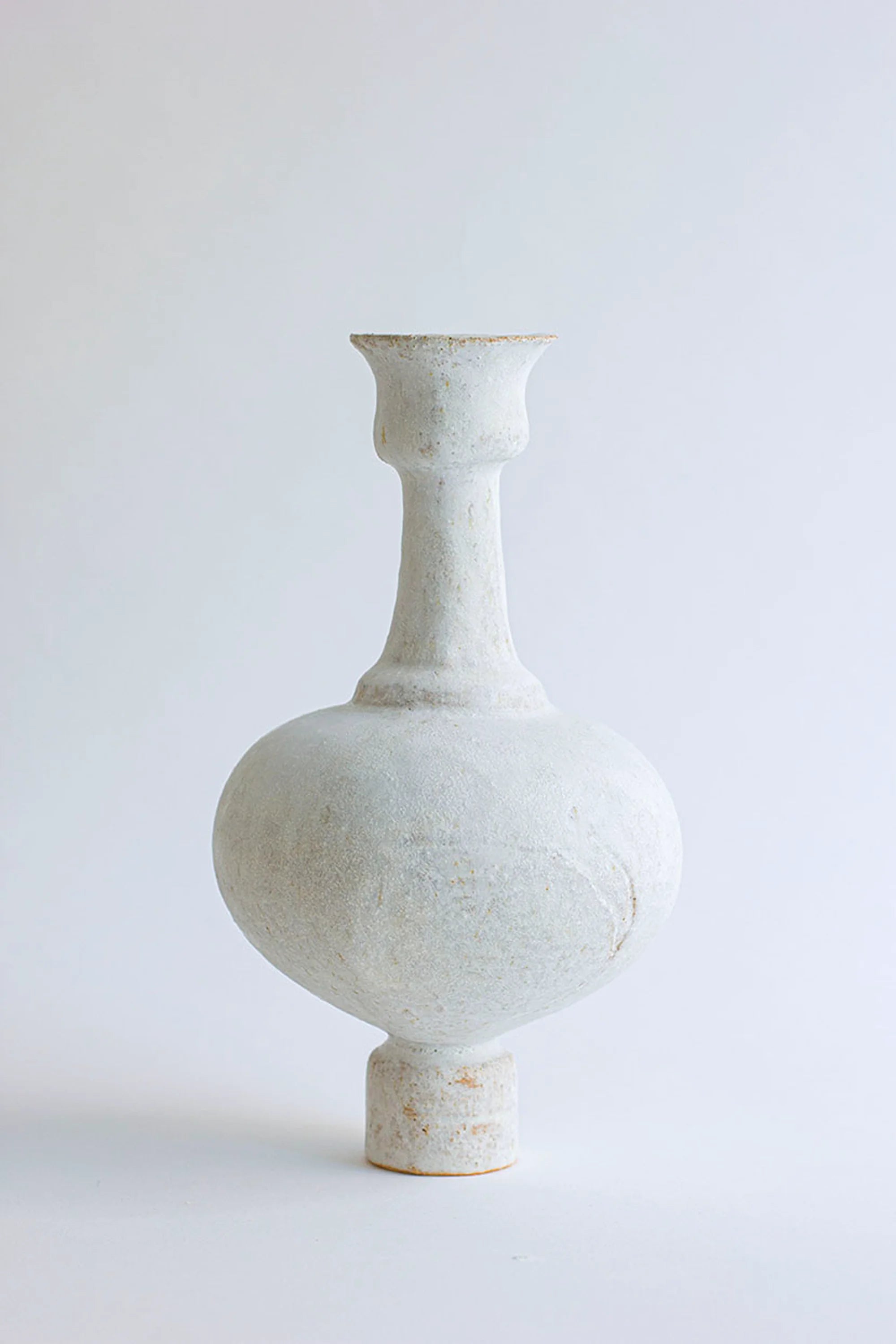 White ceramic vase on a light gray background