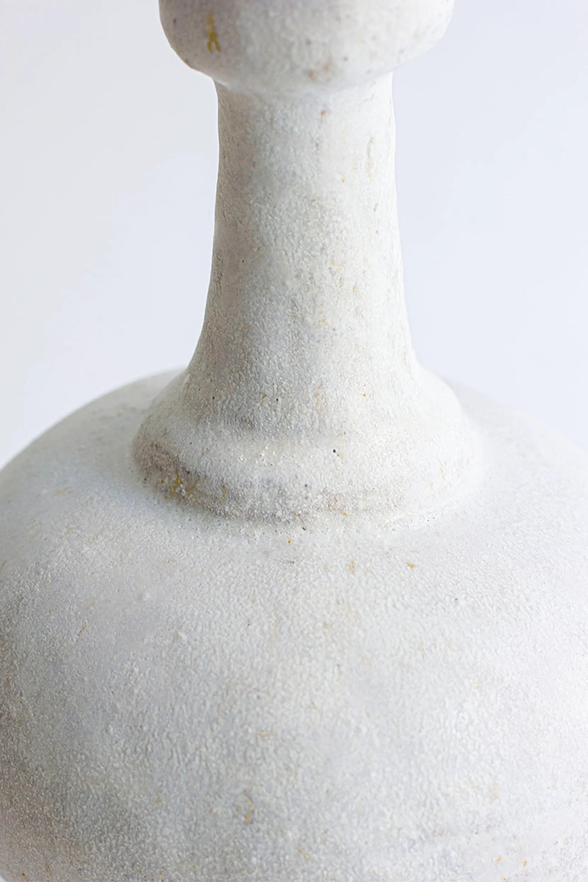 Close-up of a white marble vase on a light gray background