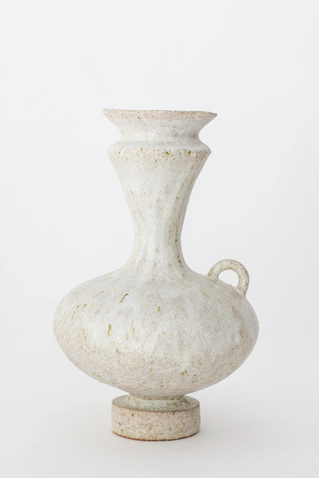 Canoa Lab Arq 006 Vase, an elegant, tall ceramic vase with a slender neck, bulbous body, and a small, decorative handle. The vase features a speckled off-white finish with subtle earthy tones, resting on a sturdy, round base. Displayed on a clean white background.