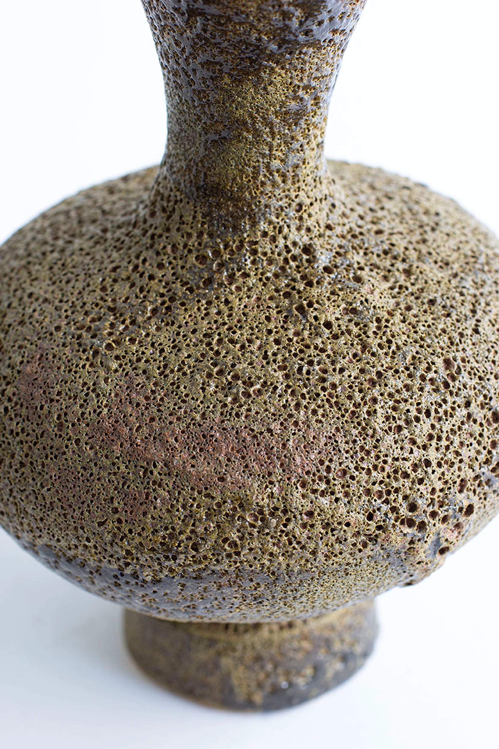 Textured ceramic vase on a white background