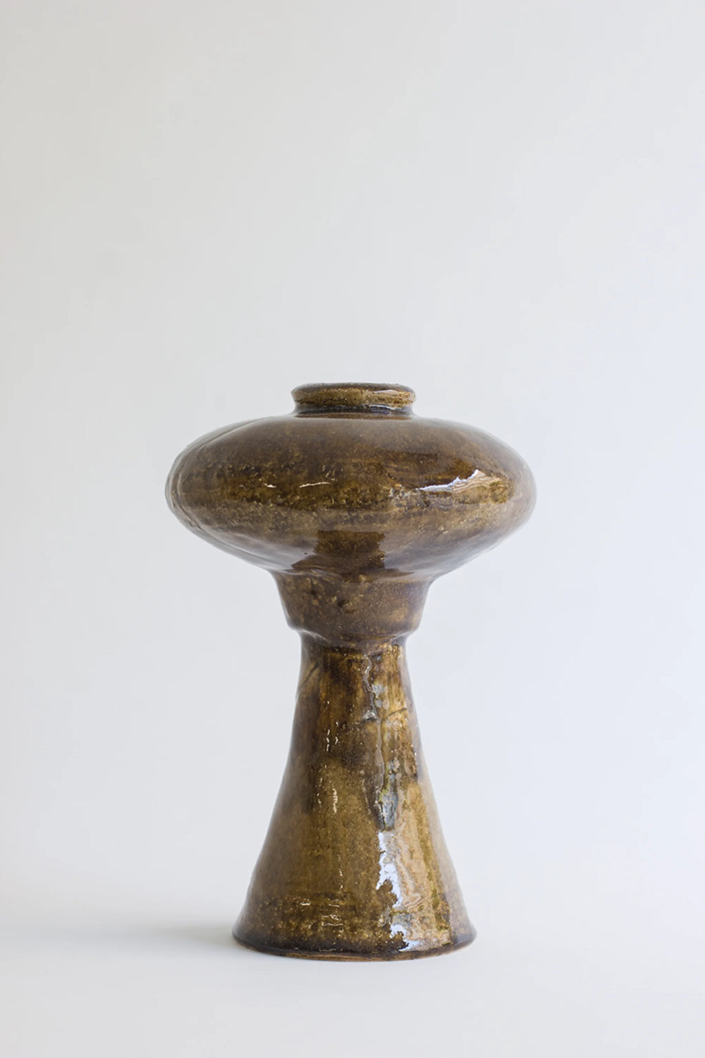 Canoa Lab Arq 009 Vase, showcasing its unique, sculptural form with a glossy dark brown finish and subtle textured details, featuring a wide, flat top and a tapering base, on a white background.