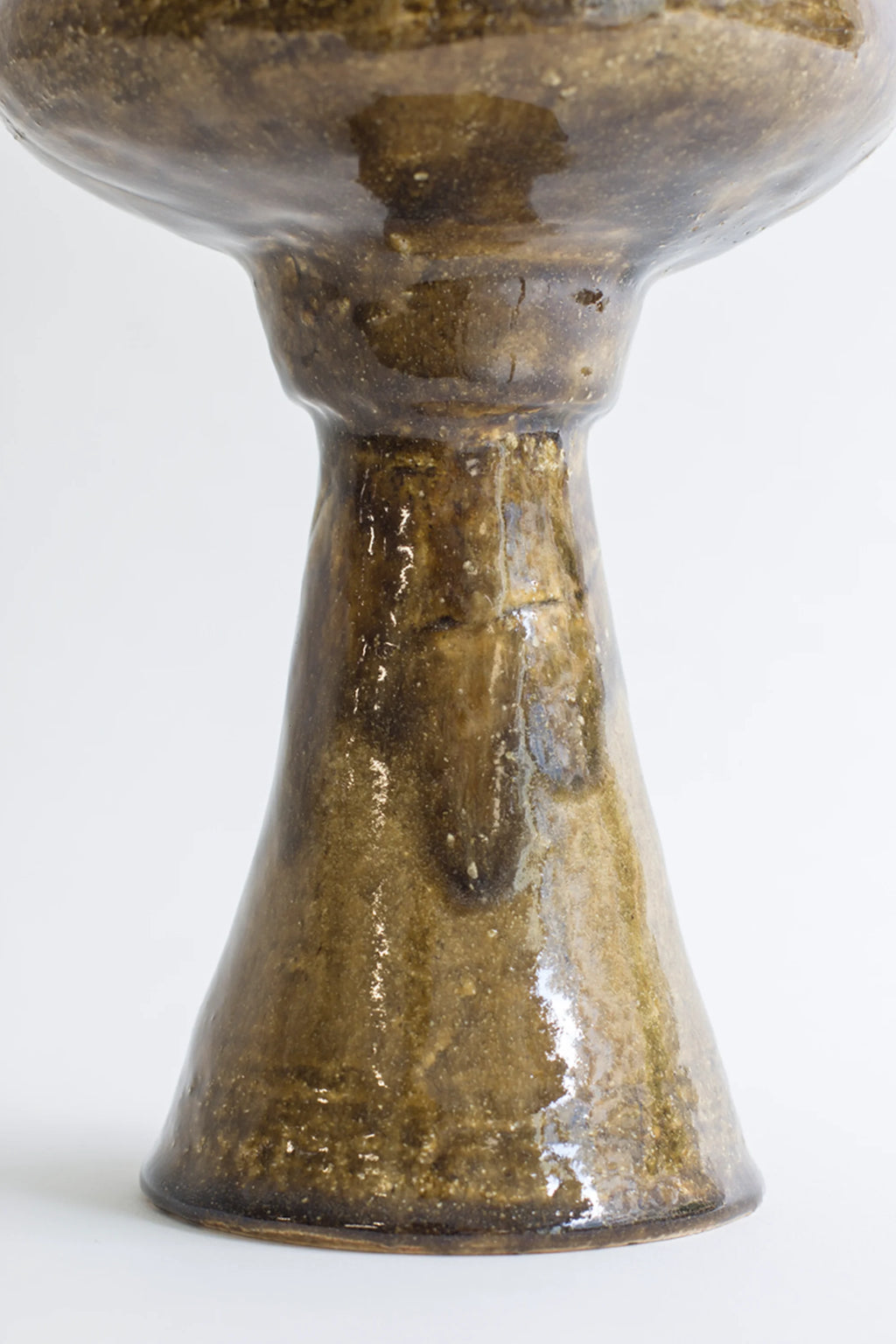 Canoa Lab Arq 009 Vase, a unique handcrafted ceramic vase with a glossy, organic dark brown and green glaze, featuring a flared base and elegant stem, displayed on a clean white background.