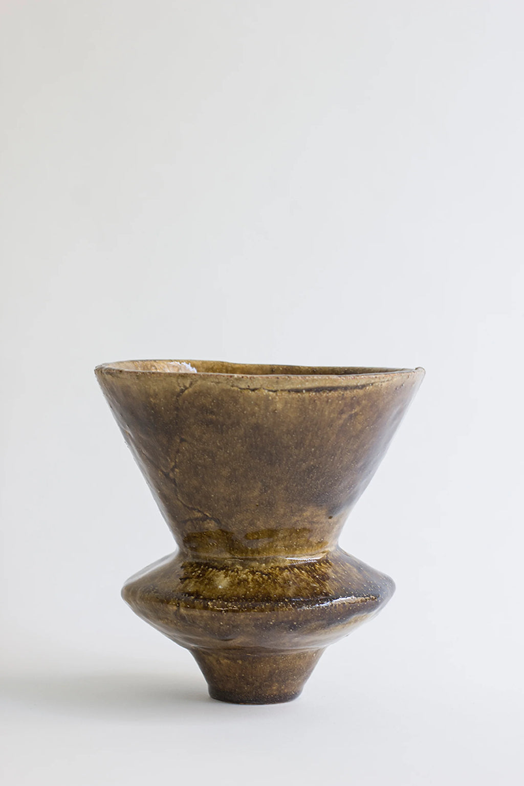 Canoa Lab Arq 010 Vase, a unique, handcrafted ceramic vase with a rich, glossy dark brown glaze and textured finish, featuring a flared top and bulbous base, displayed on a clean white background.