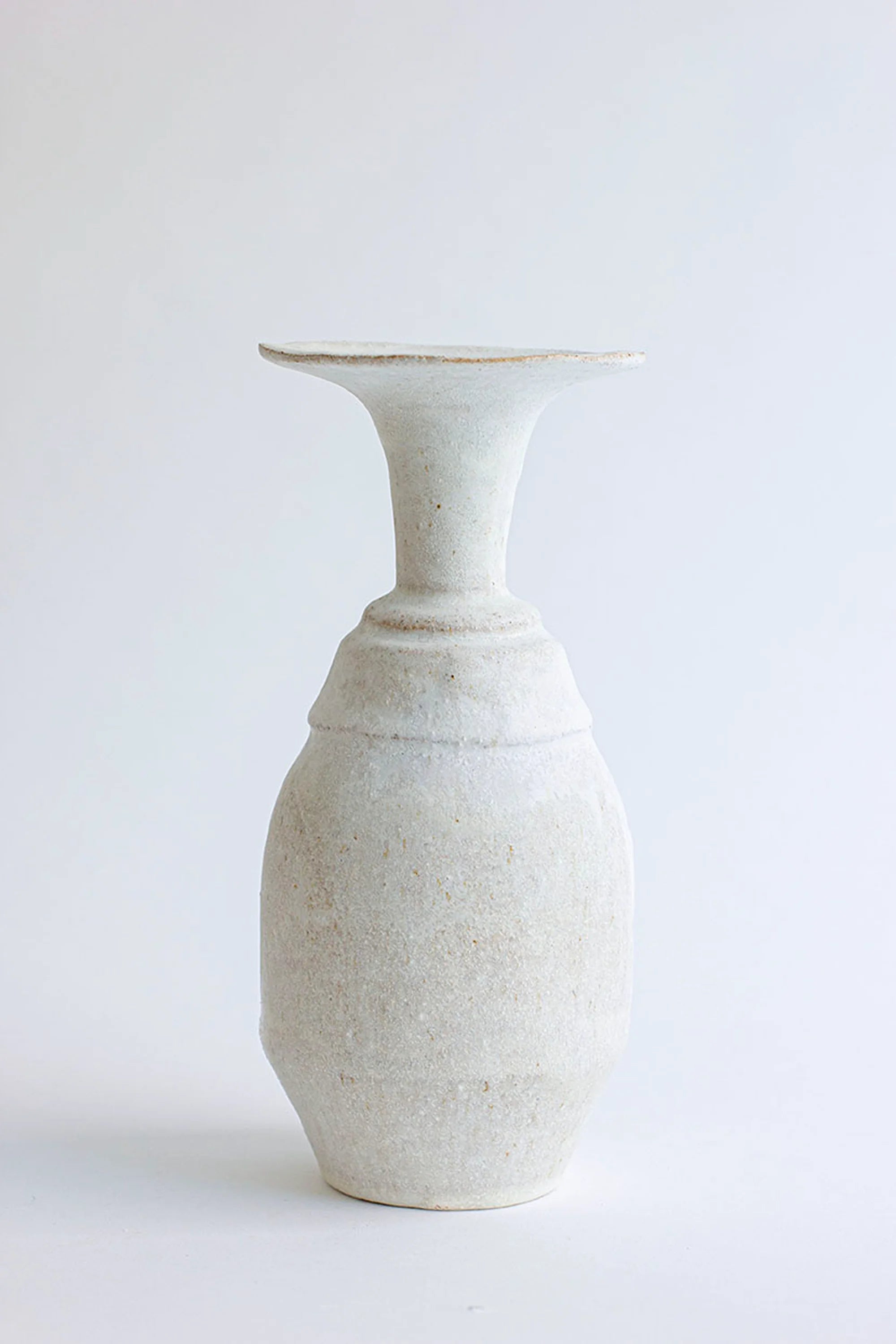 White ceramic vase on a white background