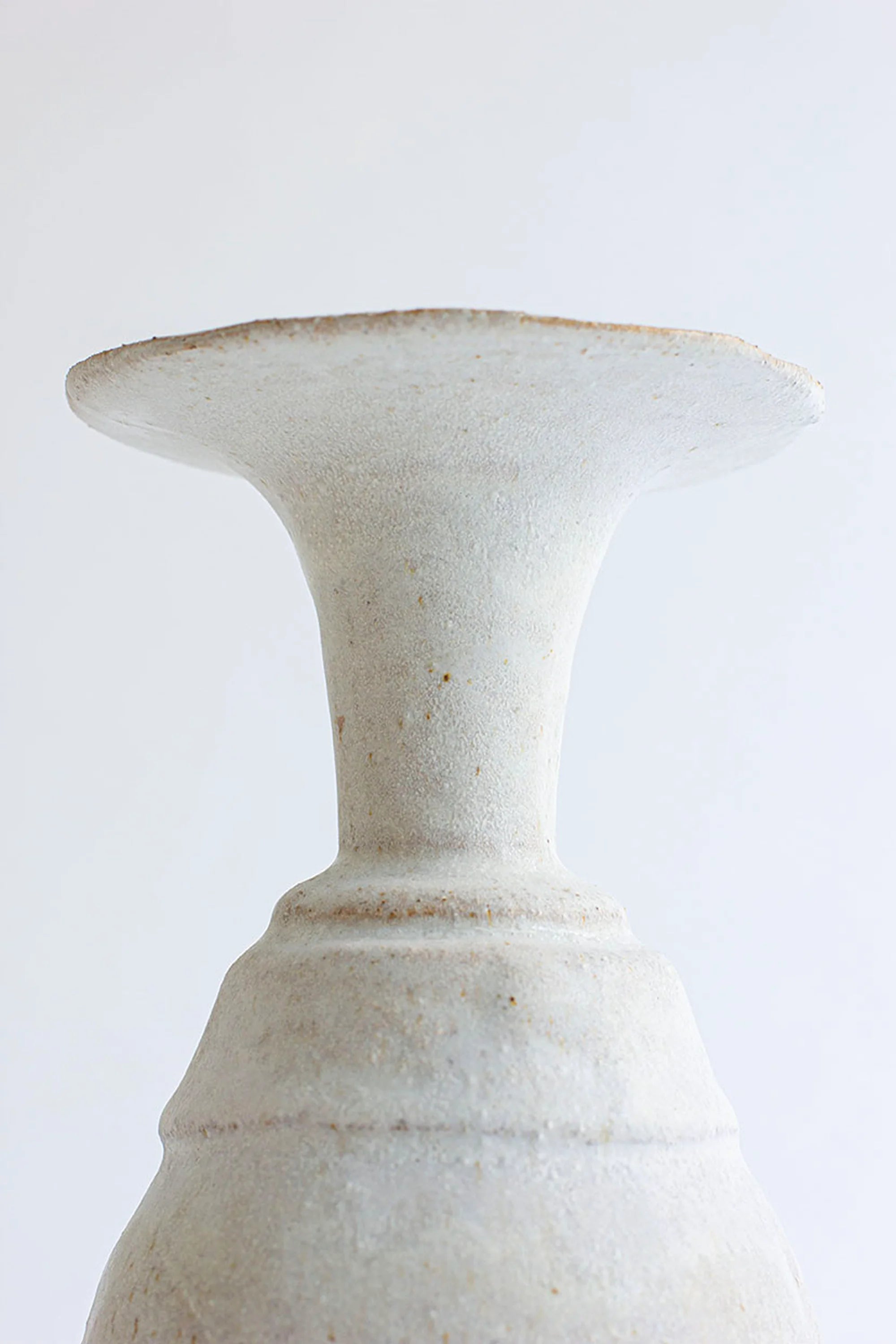 White ceramic vase on a light gray background