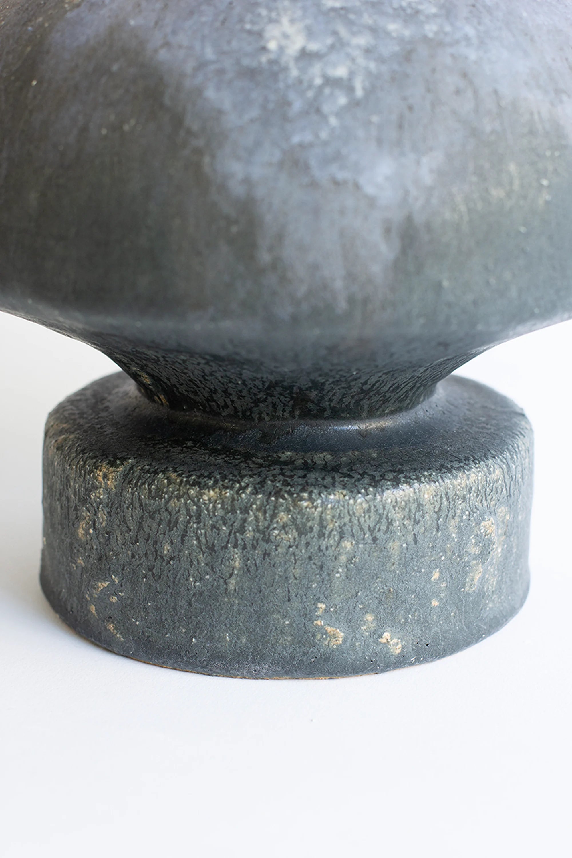 Close-up of a textured stone sphere on a white background
