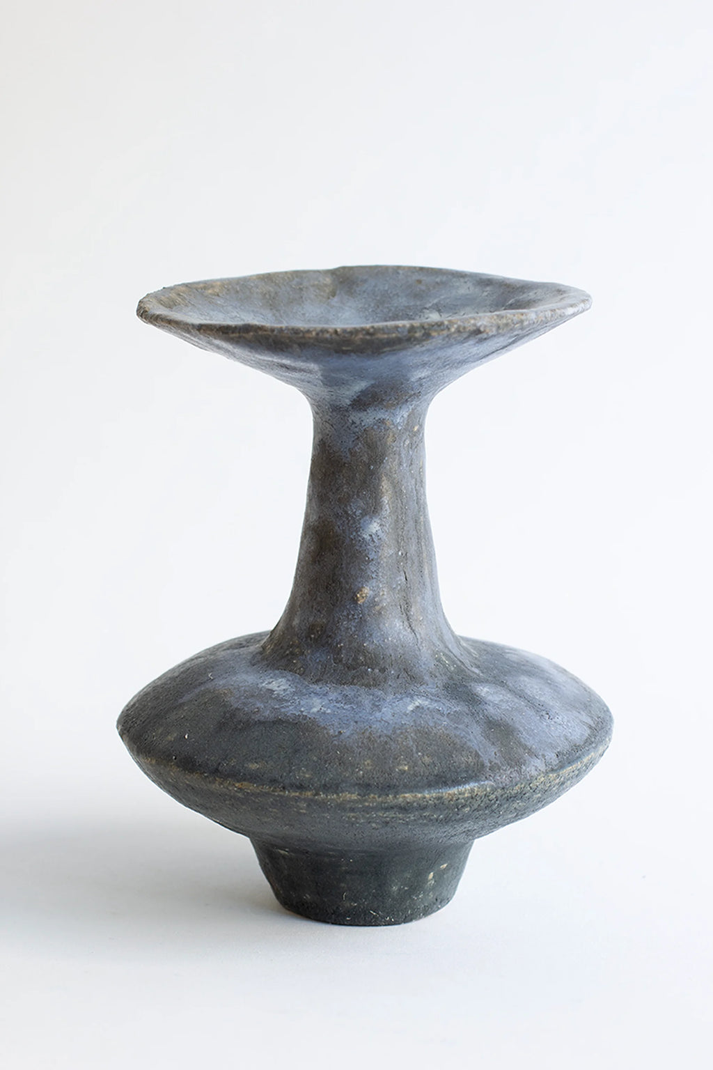 Canoa Lab Arq 015 Vase, a modern, handcrafted ceramic vase with a wide, flared top and a dark, textured charcoal gray finish, featuring a unique hourglass silhouette, displayed on a white background.