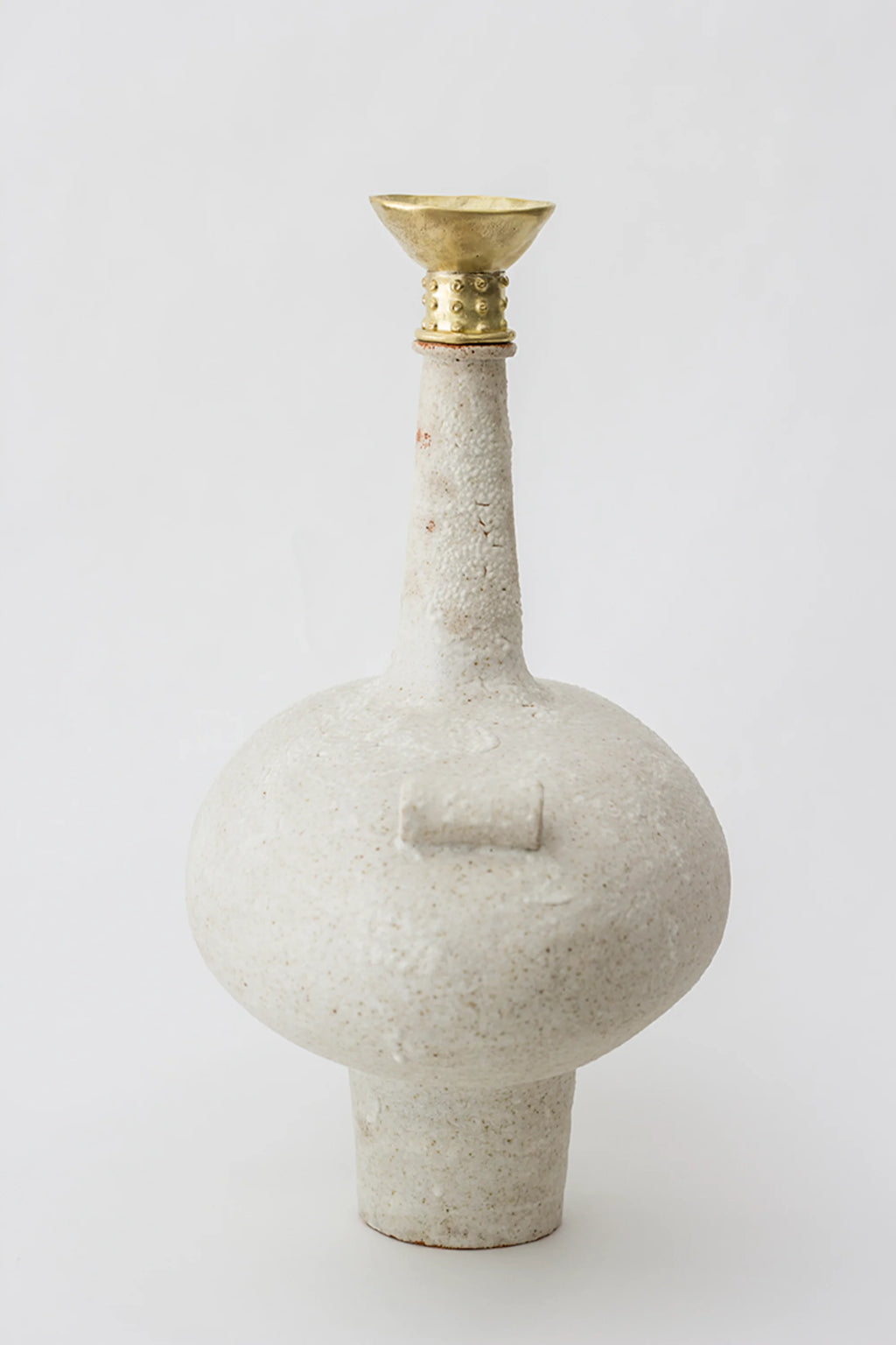Canoa Lab Isolated n.13 Vase, a full-length view of the unique, bulbous off-white ceramic body with a slender neck and a golden brass funnel top, featuring a small rectangular handle, on a white background.