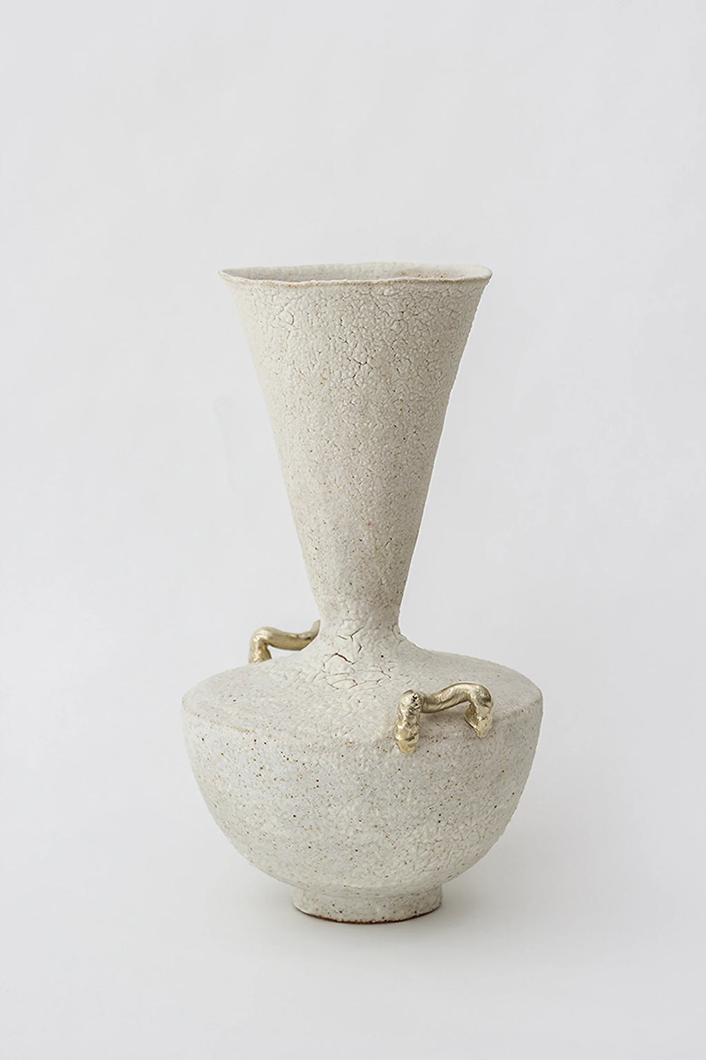 Canoa Lab Isolated n.15 Vase, a modern, textured off-white ceramic vase with a conical neck and distinctive small brass handles on the rounded body, on a white background.