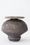 Textured ceramic vase on a white background