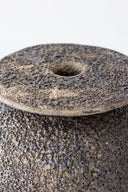 Close-up of a textured stone object with a white background