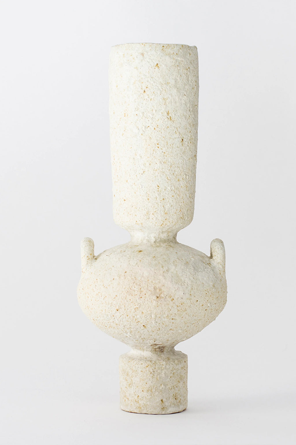 Canoa Lab Isolated n.23 Vase, a modern, sculptural ceramic vase in a textured, matte off-white finish, featuring a tall, cylindrical neck, a rounded body with small handles, and a sturdy base, on a white background.