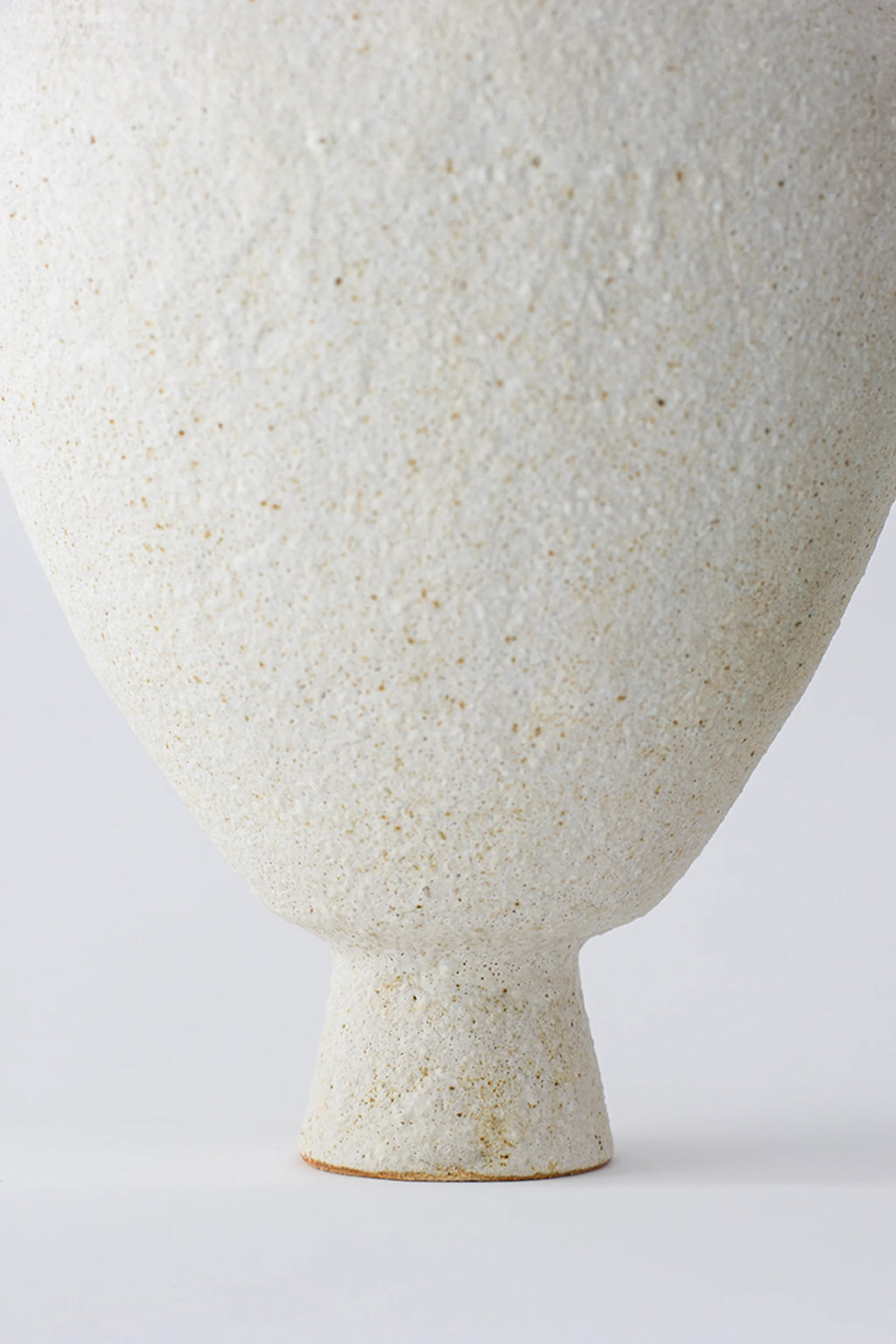 Canoa Lab Isolated n.24 Vase, showcasing its unique textured, off-white ceramic base and sturdy, minimalist design, with a subtle golden hue visible in the material, displayed on a white background.