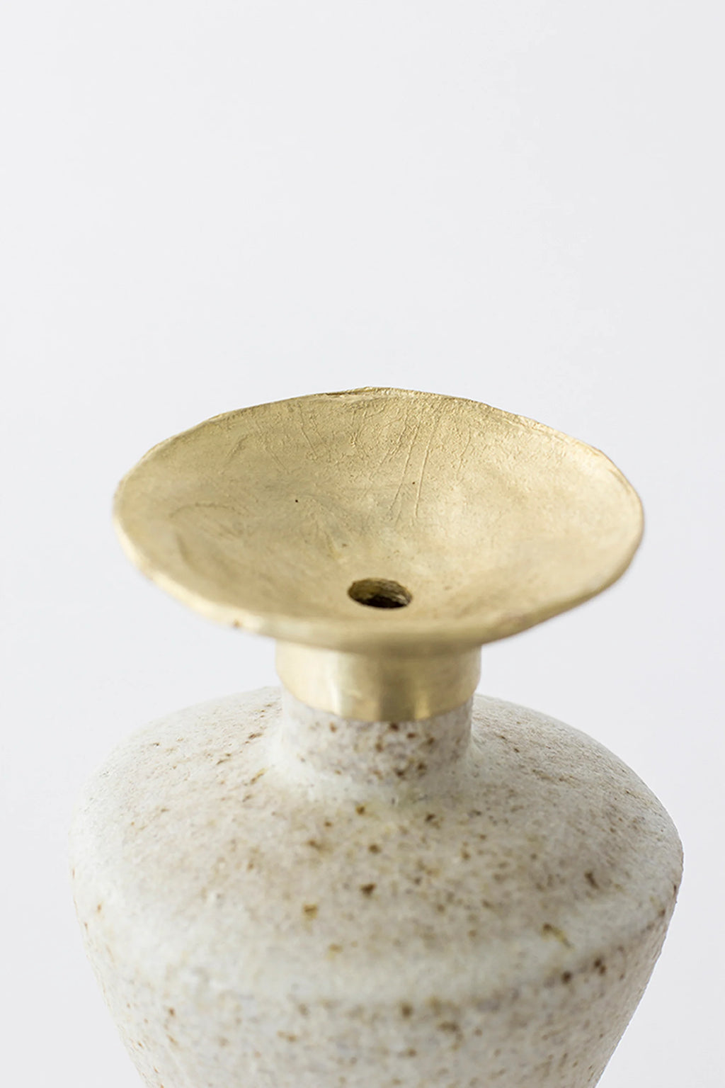 Canoa Lab Isolated n.6 Vase, a close-up of the elegant brass top with a small central opening, showcasing its textured, slightly distressed golden finish on a white background.