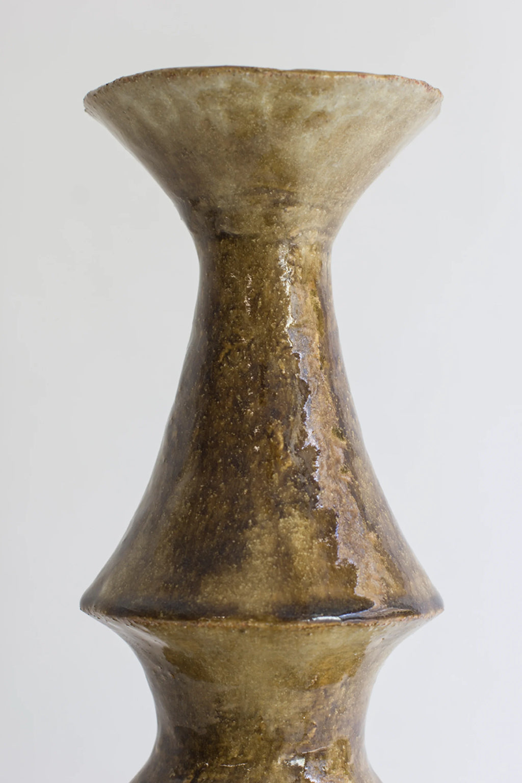 Canoa Lab Isolated n.28 Vase, a close-up of the vase's upper section, revealing its elegant, tapered neck and flared rim, with a glossy, textured brown and beige ceramic finish, displayed on a white background.