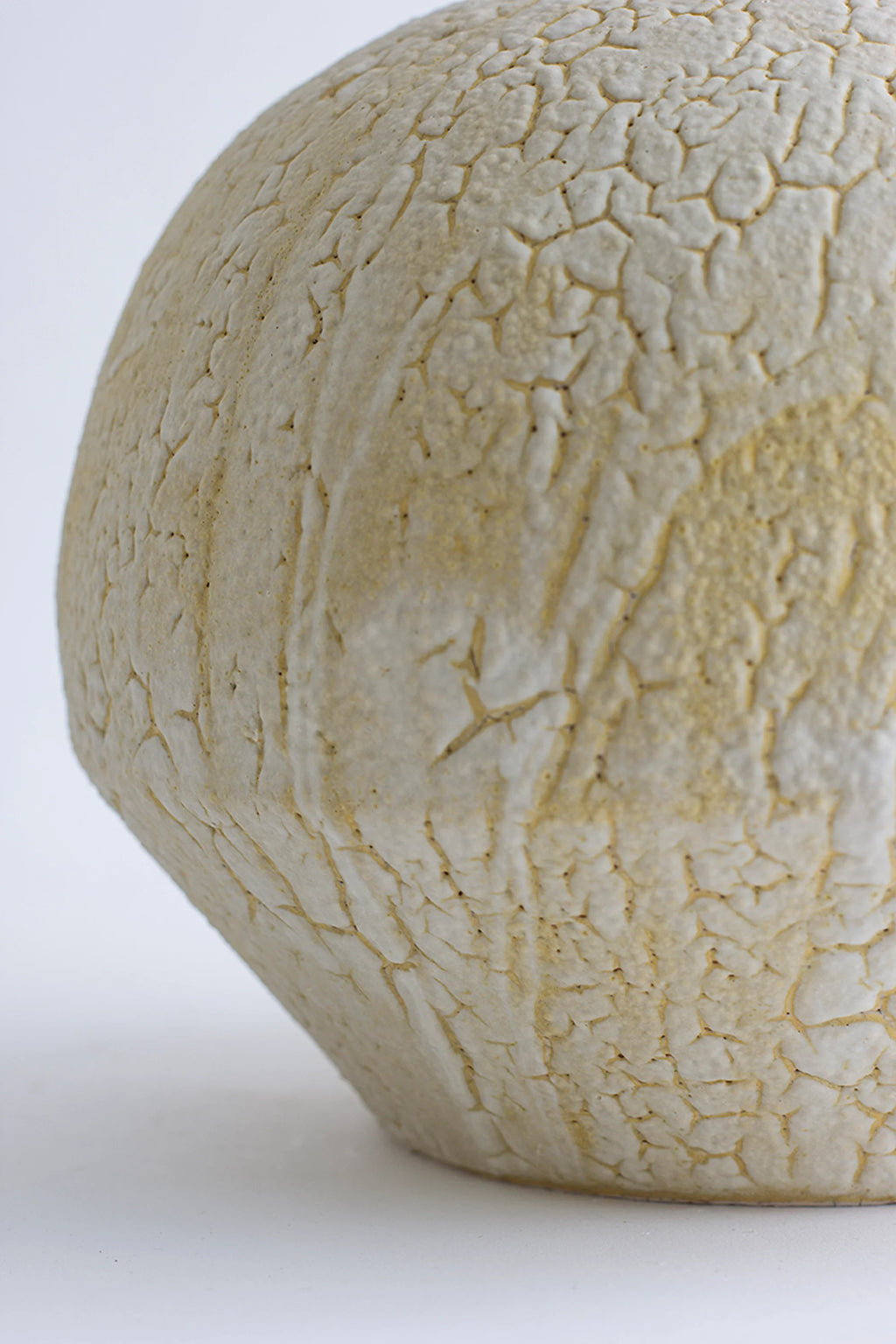 Canoa Lab Isolated n.30 Vase, a handcrafted ceramic vase featuring a distinctive crackled and porous texture in natural cream and warm beige tones, with an organic, globular silhouette.