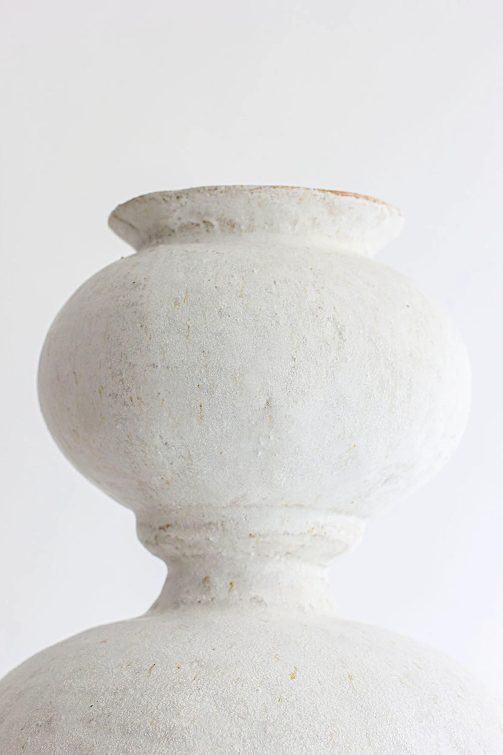 Canoa Lab Isolated n.31 Vase, a close-up of the upper, smaller bulbous section of the elegant white ceramic vase, highlighting its refined shape and matte texture.