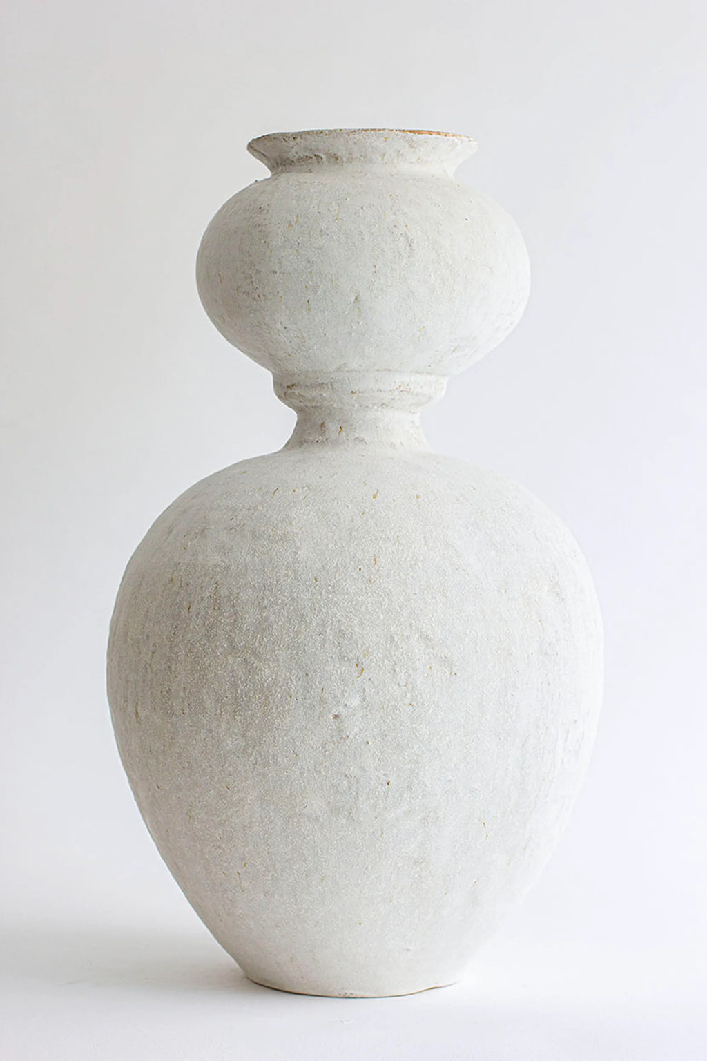 Canoa Lab Isolated n.31 Vase, an elegant, tall, white ceramic vase with a unique stacked, bulbous silhouette and a subtly textured, matte finish, displayed on a white background.