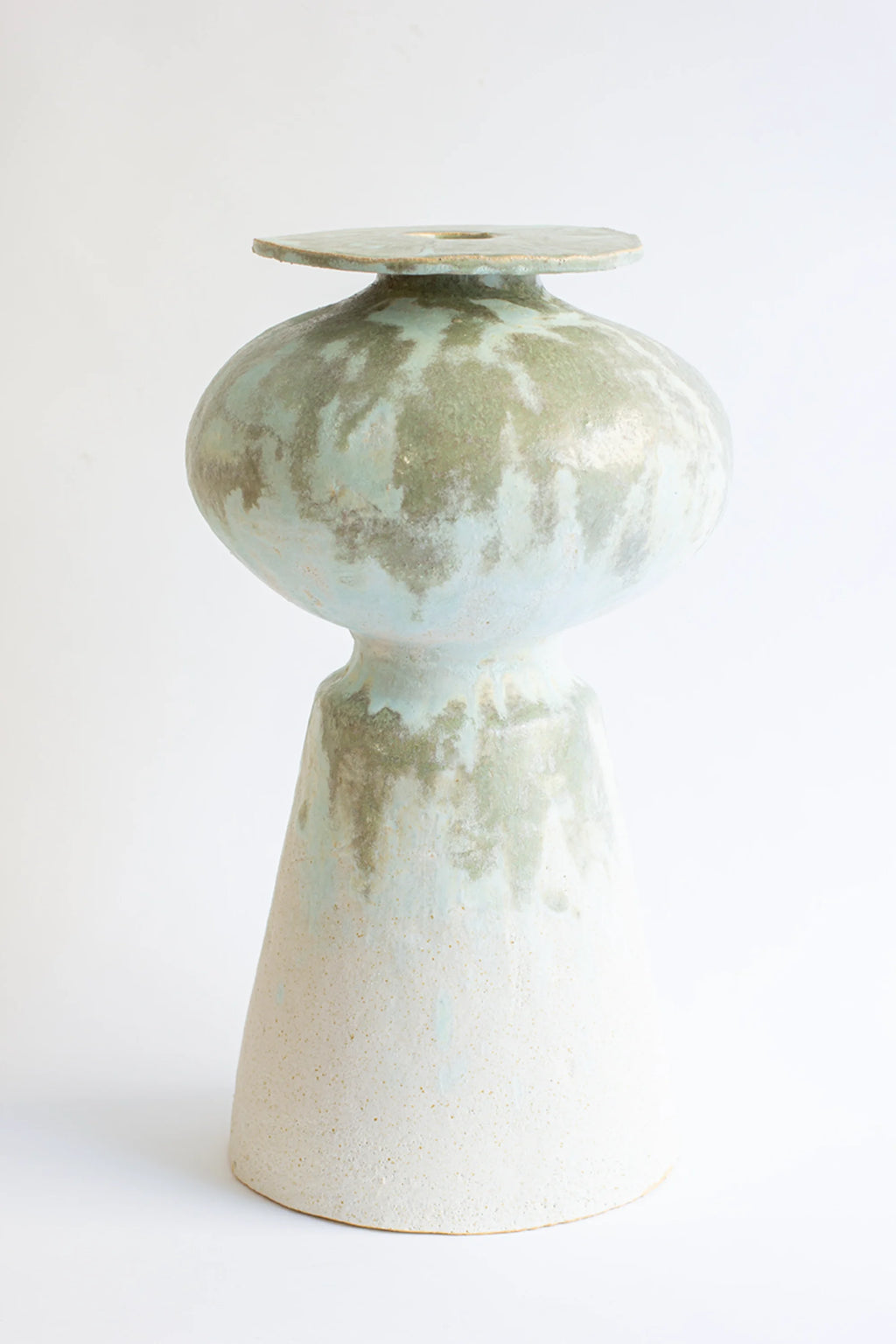 Canoa Lab Isolated n.33 Vase, a unique ceramic piece with a bulbous body and conical base, featuring a serene light blue and earthy green glaze, displayed on a clean white background.