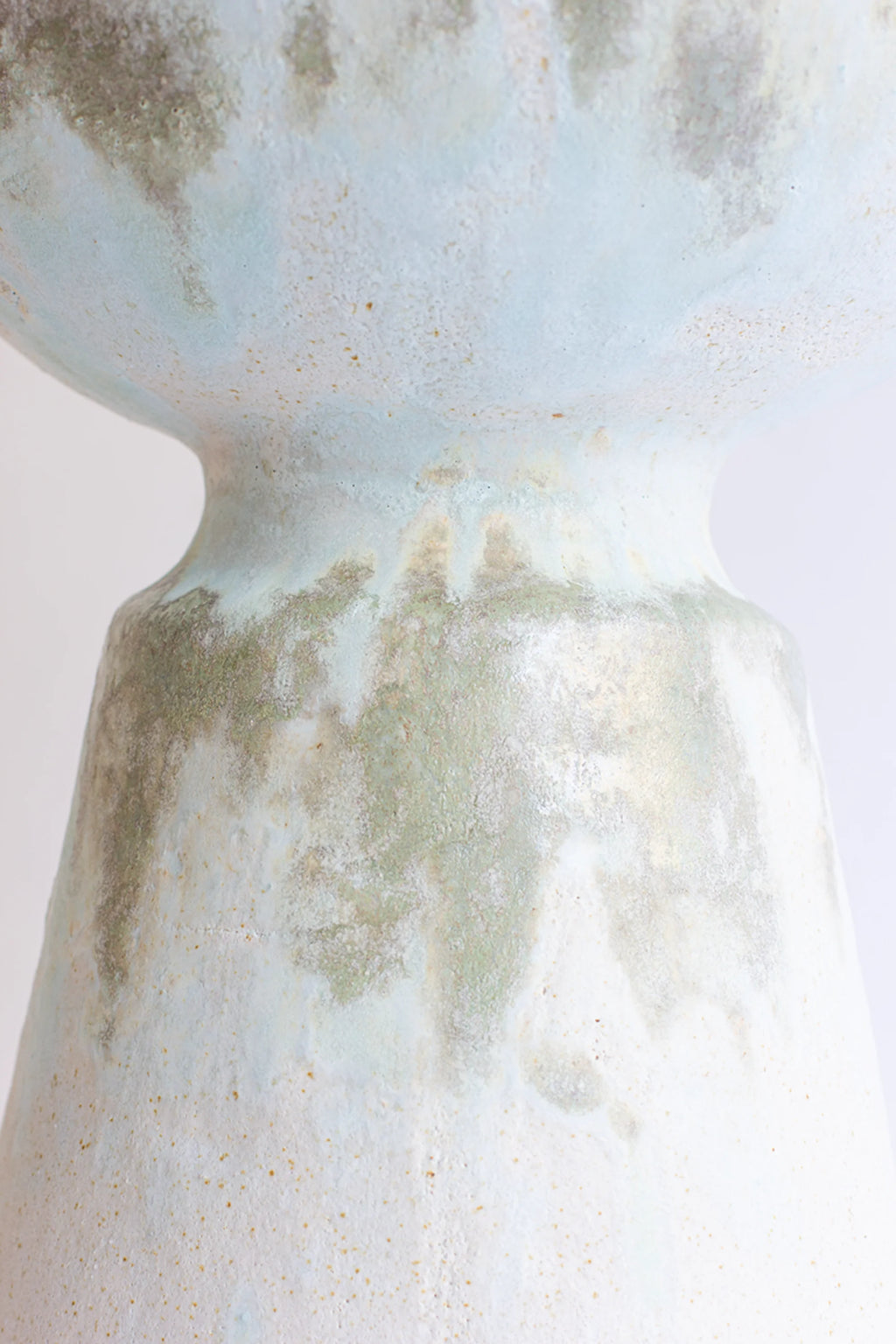 Canoa Lab Isolated n.33 Vase, a detailed view of the mid-section, showcasing the transition from the bulbous top to the conical base, with a beautiful light blue and green textured glaze.