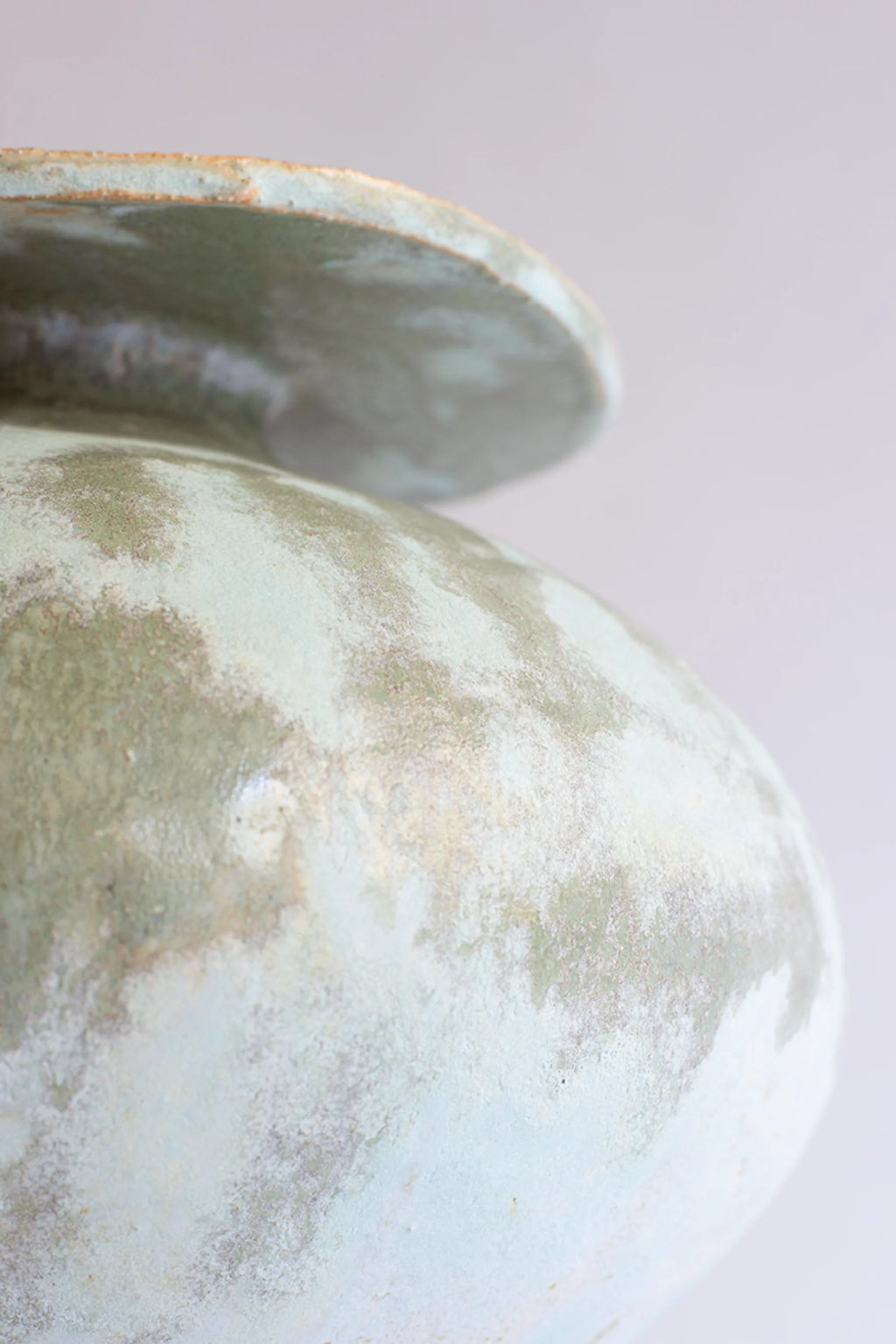 Canoa Lab Isolated n.33 Vase, a close-up of the bulbous body, revealing the intricate patterns and subtle color variations of the light blue and green glaze, on a white background.