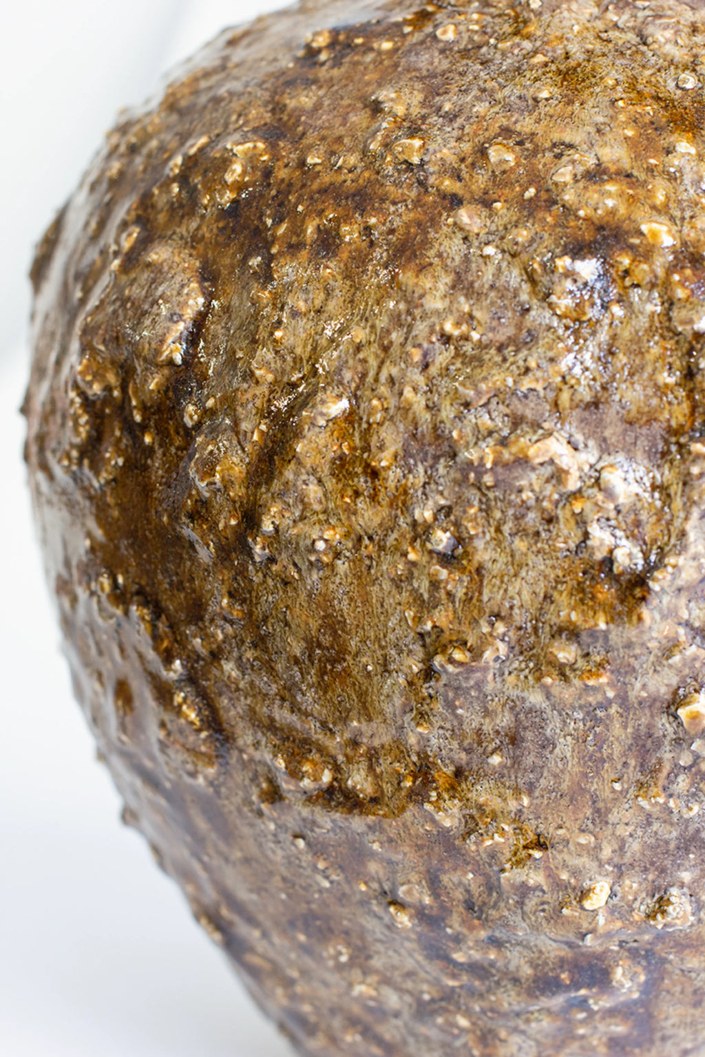 Canoa Lab Isolated n.34 Vase, a close-up of the textured body, revealing the intricate, granular surface and the deep, glossy dark brown glaze, emphasizing its unique artisanal quality.