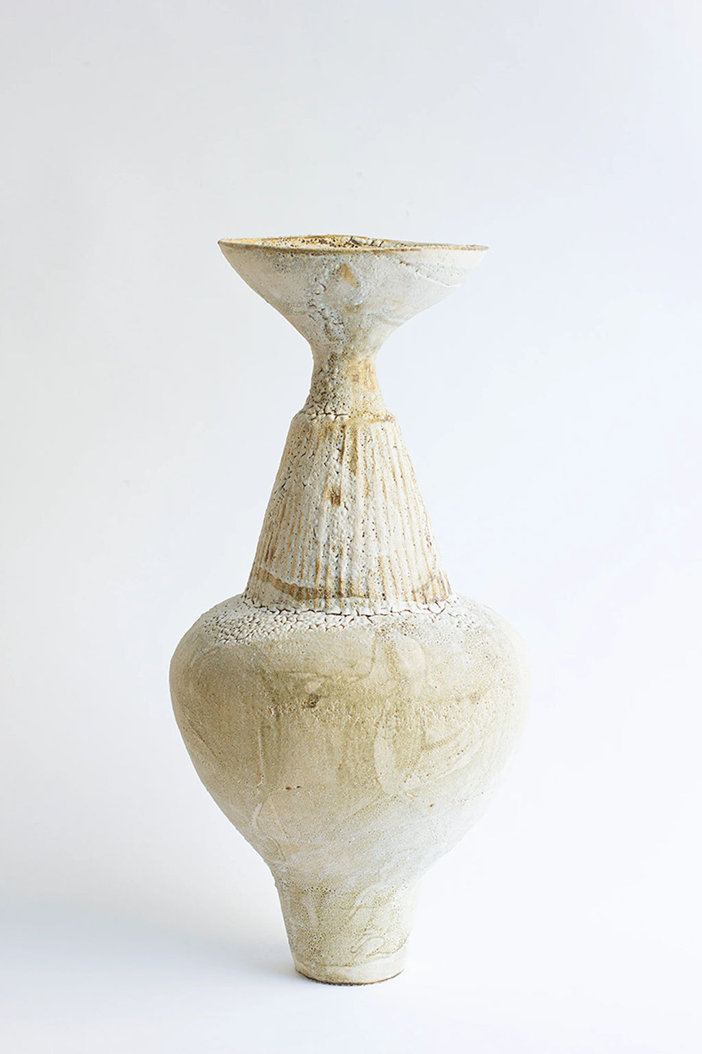Canoa Lab Isolated n.35 Vase, a tall, elegant, and uniquely shaped ceramic vase with a textured, off-white, and cream finish, featuring a narrow neck and a wide, bulbous body, displayed on a white background.