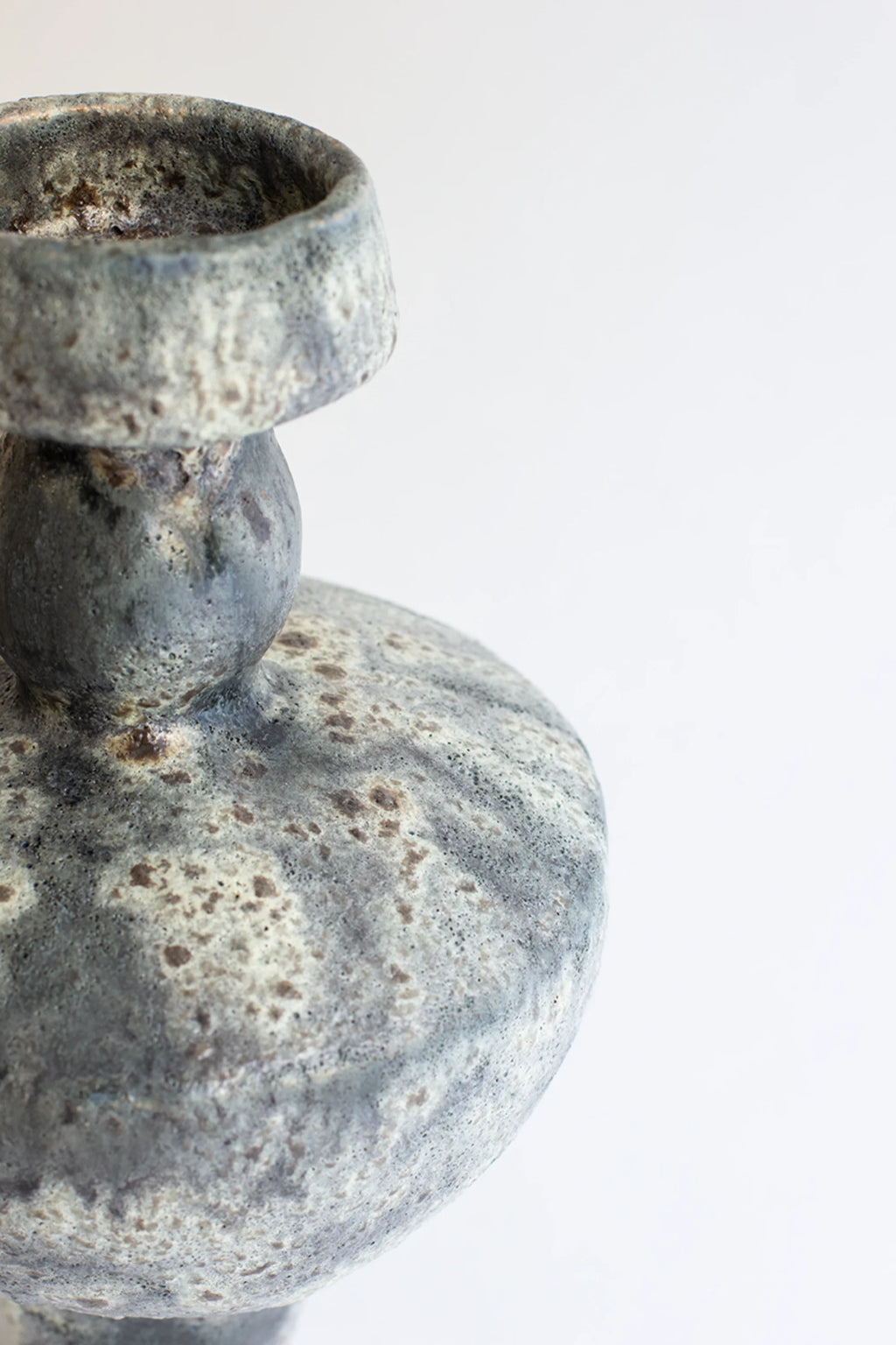 Canoa Lab Lydion Gecko Vase, a unique ceramic piece with a textured, mottled gray and white finish, featuring a distinct bulbous body and narrow neck, displayed on a clean white background.