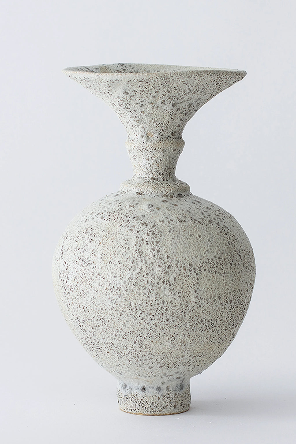Canoa Lab Ánfora Vase, an elegant, modern ceramic vase with a speckled, light gray and white textured finish, featuring a classic amphora shape with a flared rim and round body, on a white background.