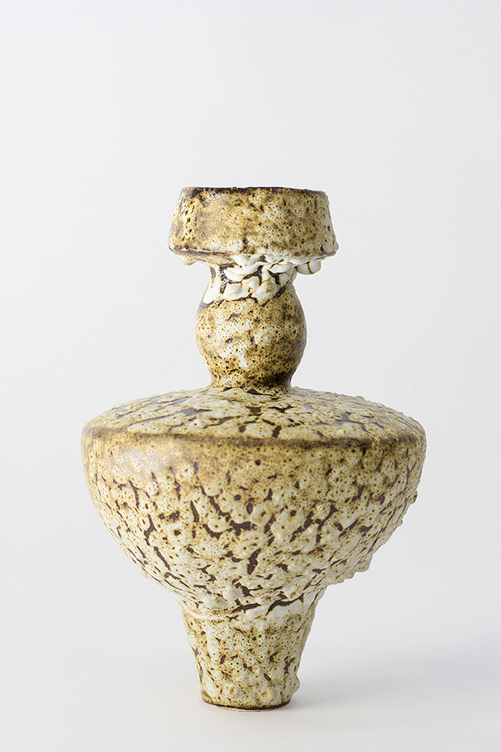 Canoa Lab Lydion Limonita Vase, a unique, textured ceramic piece with a rich earthy brown and cream speckled glaze, featuring a distinct layered, organic shape, displayed on a clean white background.