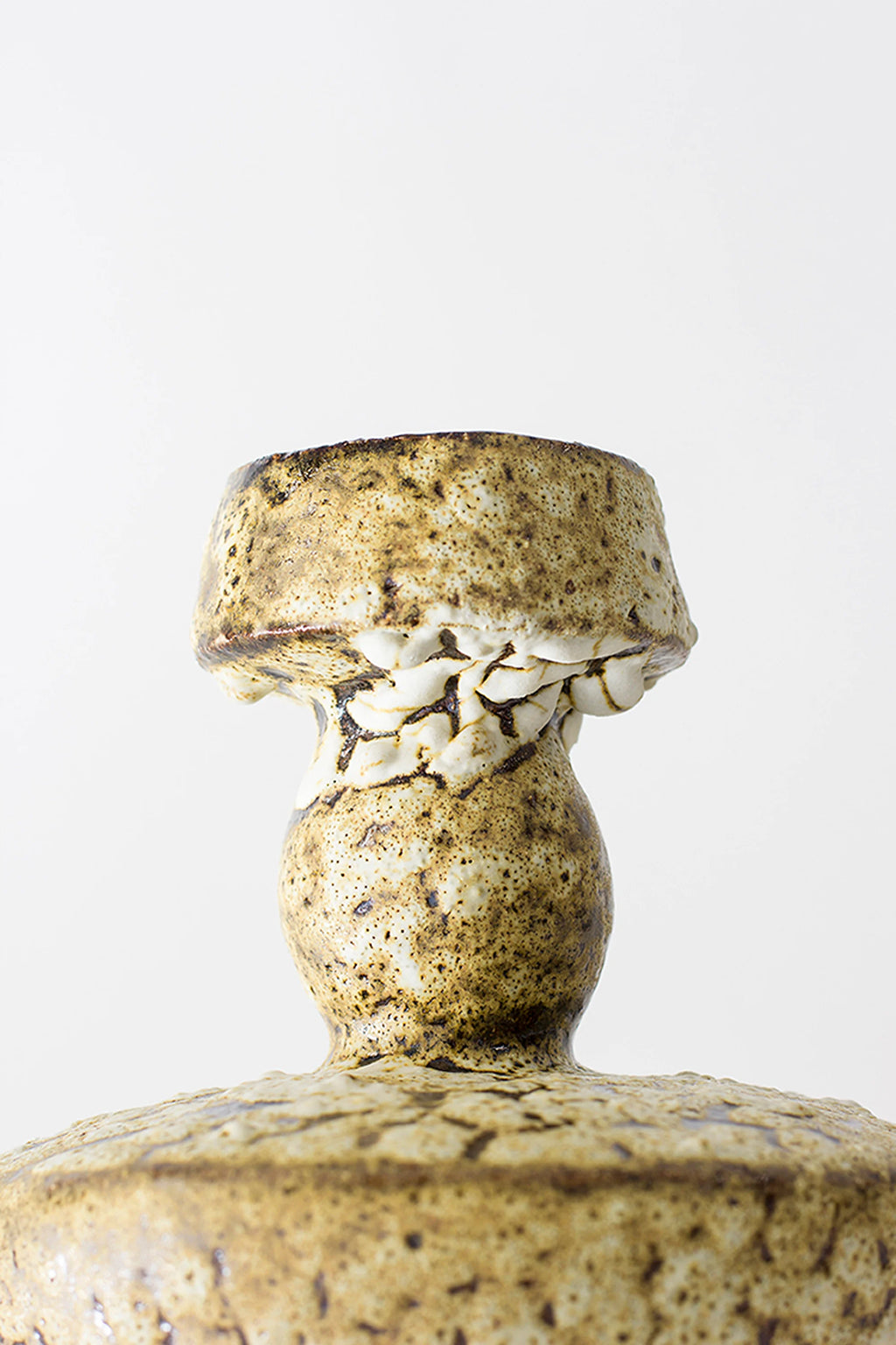 Canoa Lab Lydion Limonita Vase, a close-up of the upper section, revealing the textured, layered design with a speckled brown and cream glaze, emphasizing the unique, handcrafted details on a white background.