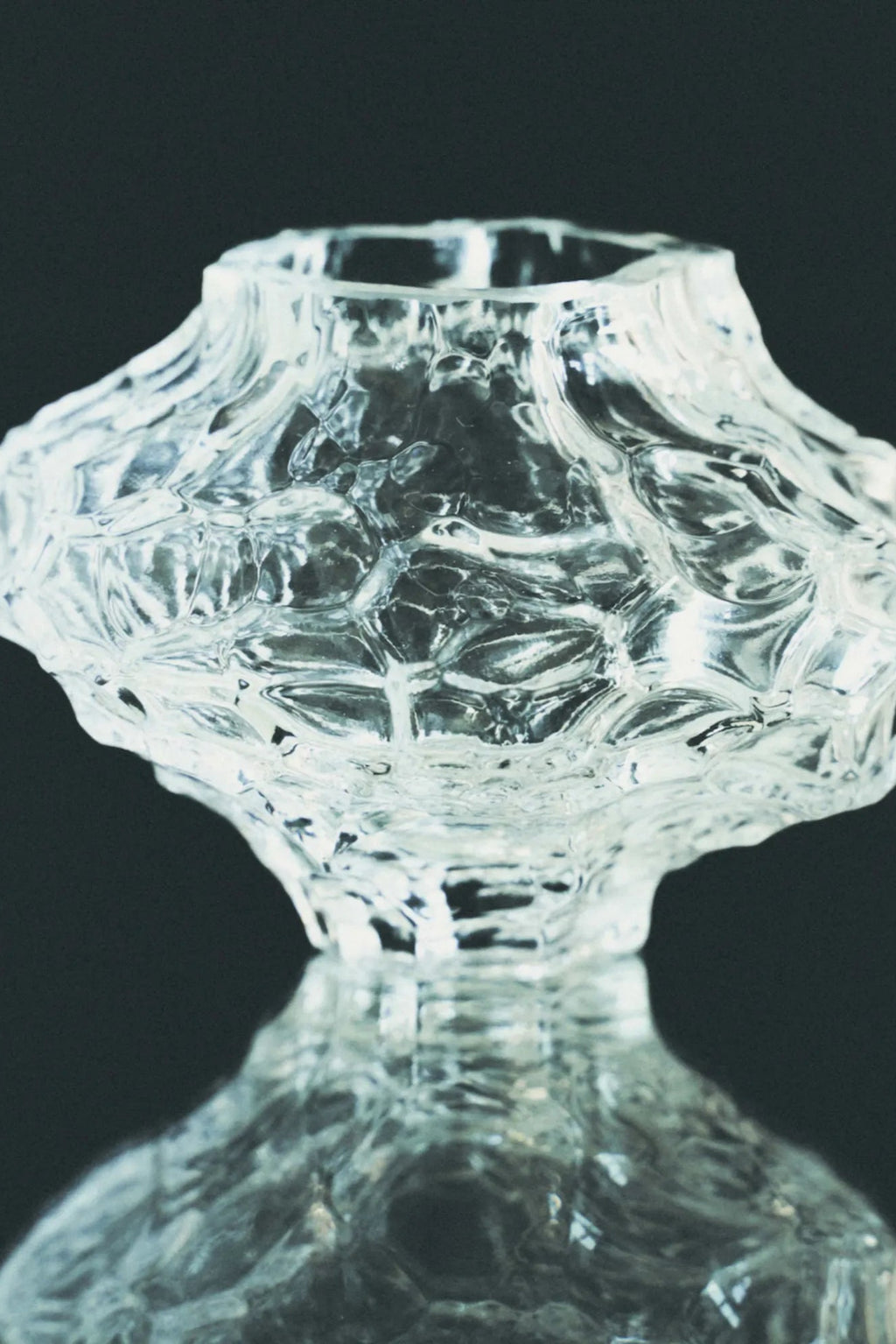 Hein Studio Canyon Vase - Mini, a clear textured glass vase featuring an organic, sculptural form reminiscent of ice or rock formations, with a unique irregular opening and a faceted, craggy surface.