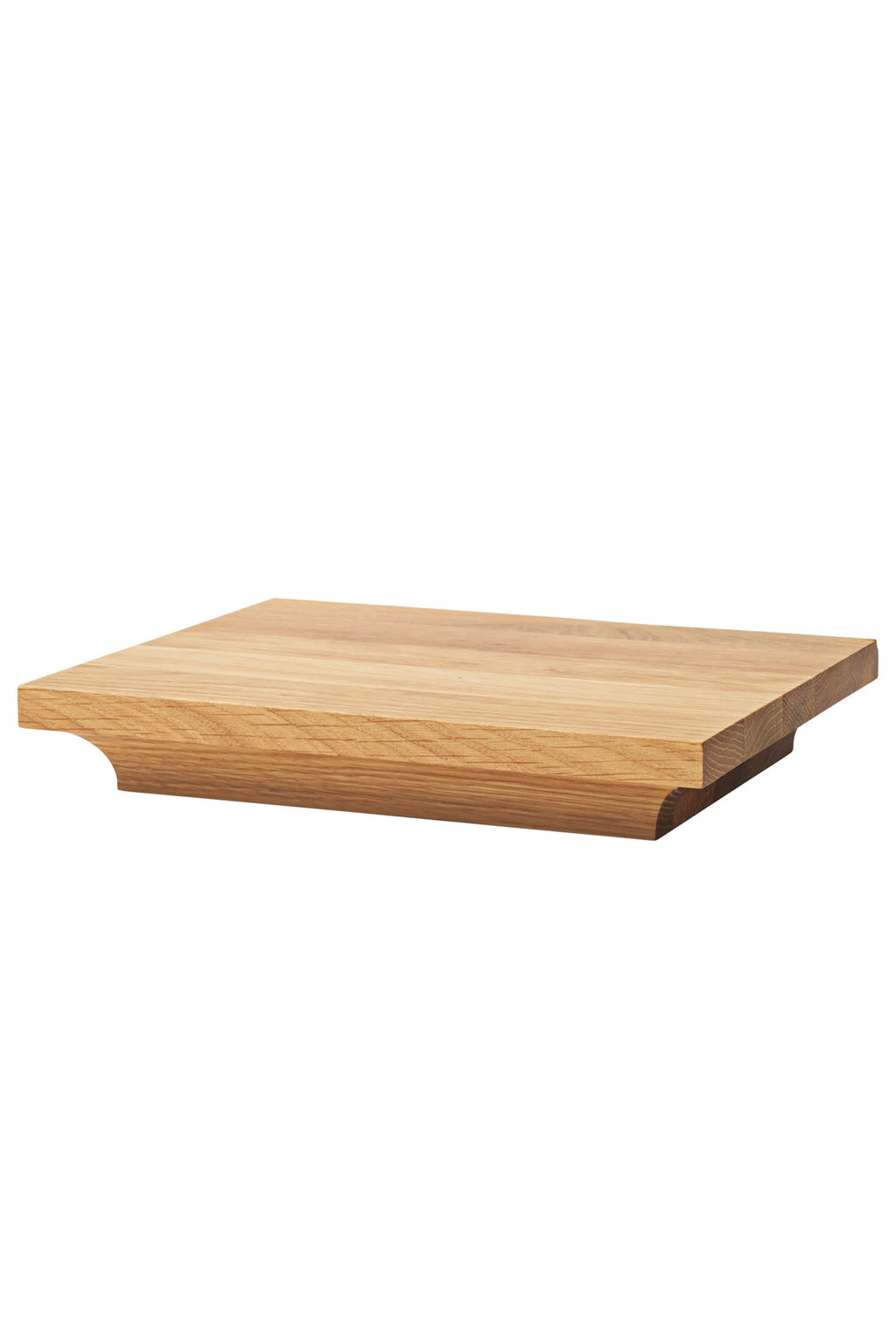 Kristina Dam Capital Podium, a modern minimalist square decorative tray crafted from light natural solid oak wood, featuring a smooth grain and a distinctive sculptural base with a curved, recessed edge that creates an elevated profile. This versatile Scandinavian wood podium is perfect for contemporary shelf styling, displaying objects in a living room, or as an organic modern serving board.
