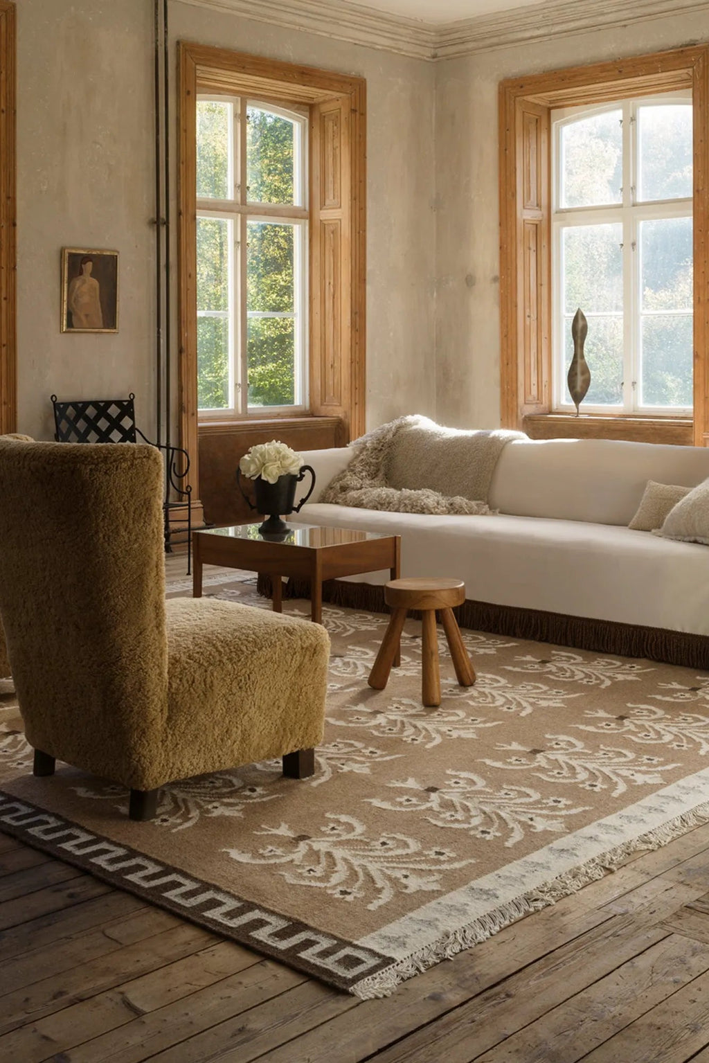 Hand-woven wool rug in earthy tones, featuring intricate geometric patterns