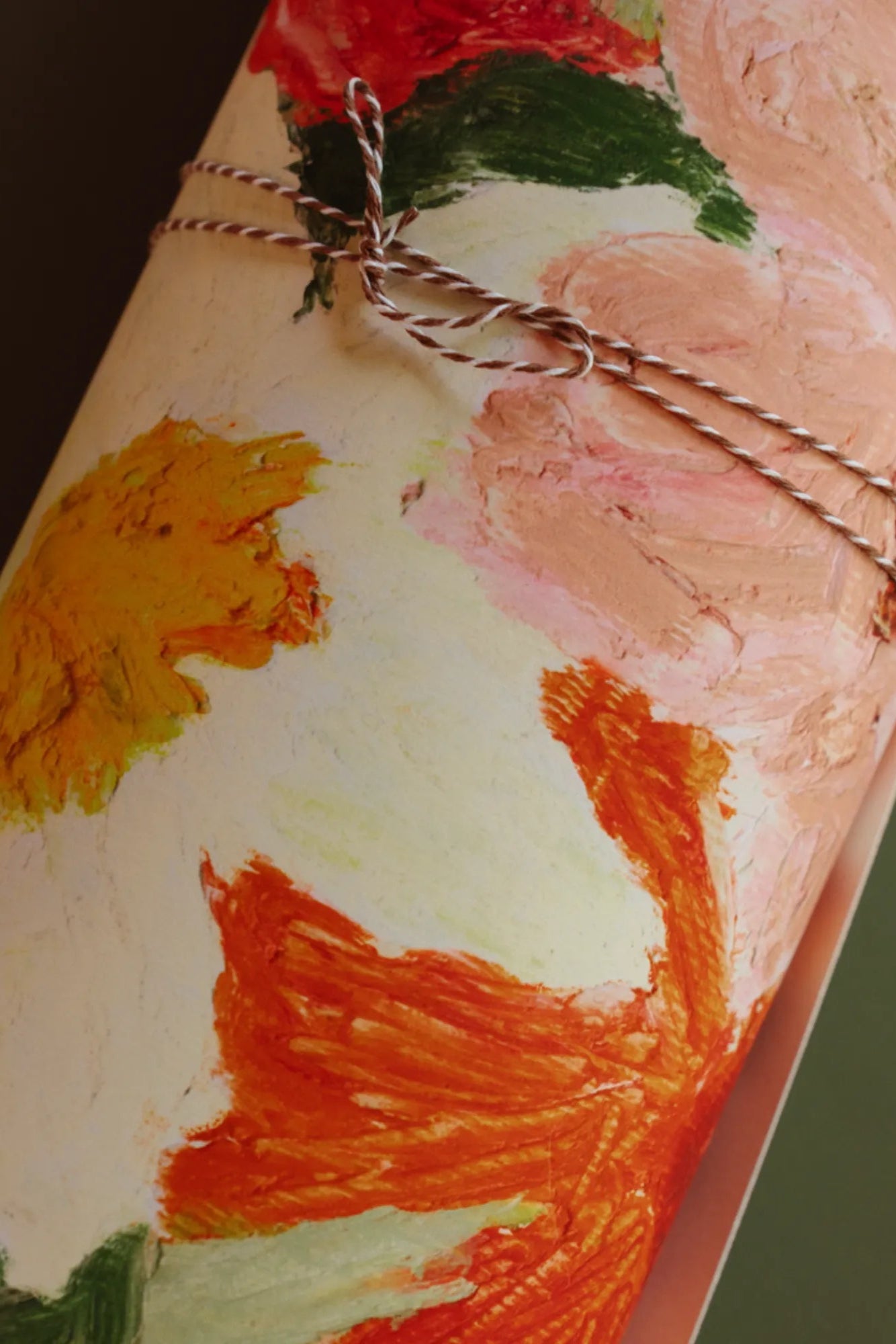 Close up of delicate pink and white flowers against a soft sage green backdrop