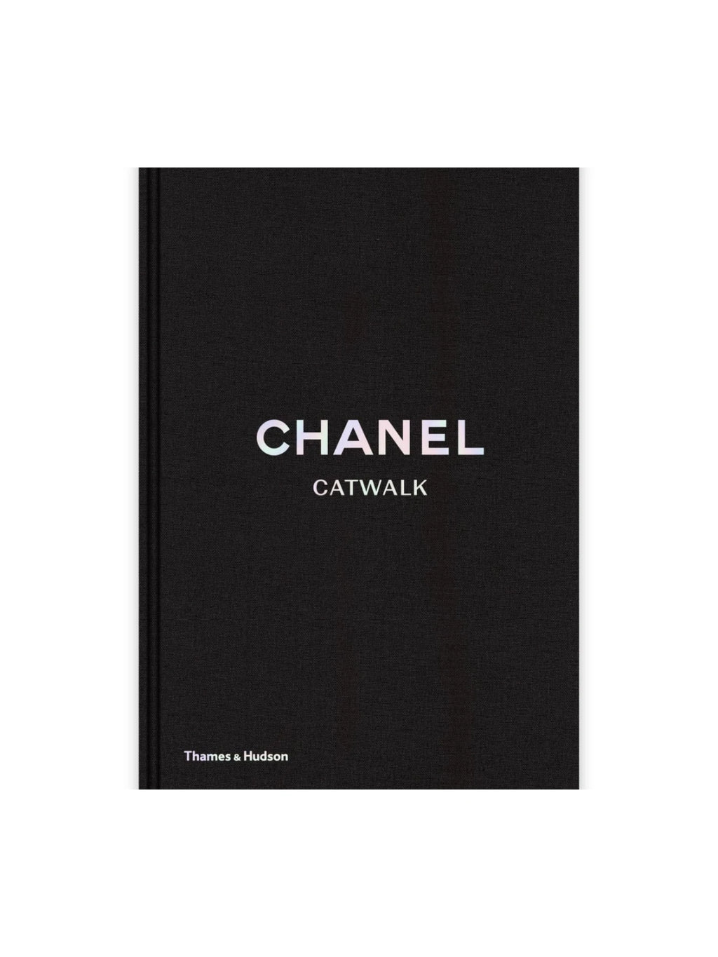 Book Chanel Catwalk, a luxurious hardcover fashion book with a textured black fabric cover and iridescent title text. This stylish coffee table book is perfect for fashion enthusiasts, designers, and collectors seeking a visual history of Chanel's iconic runway shows.